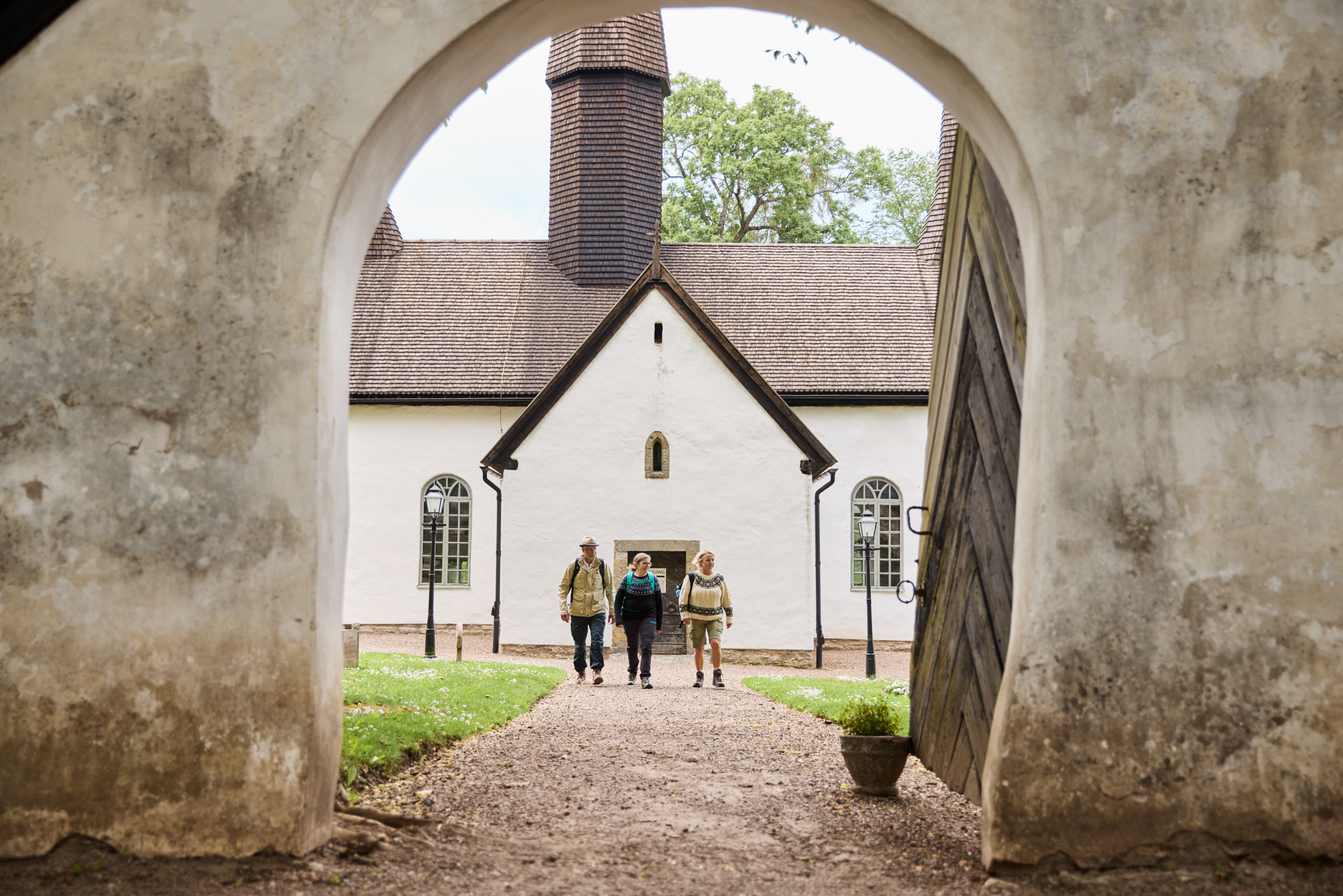 People walking by Kungslena church.