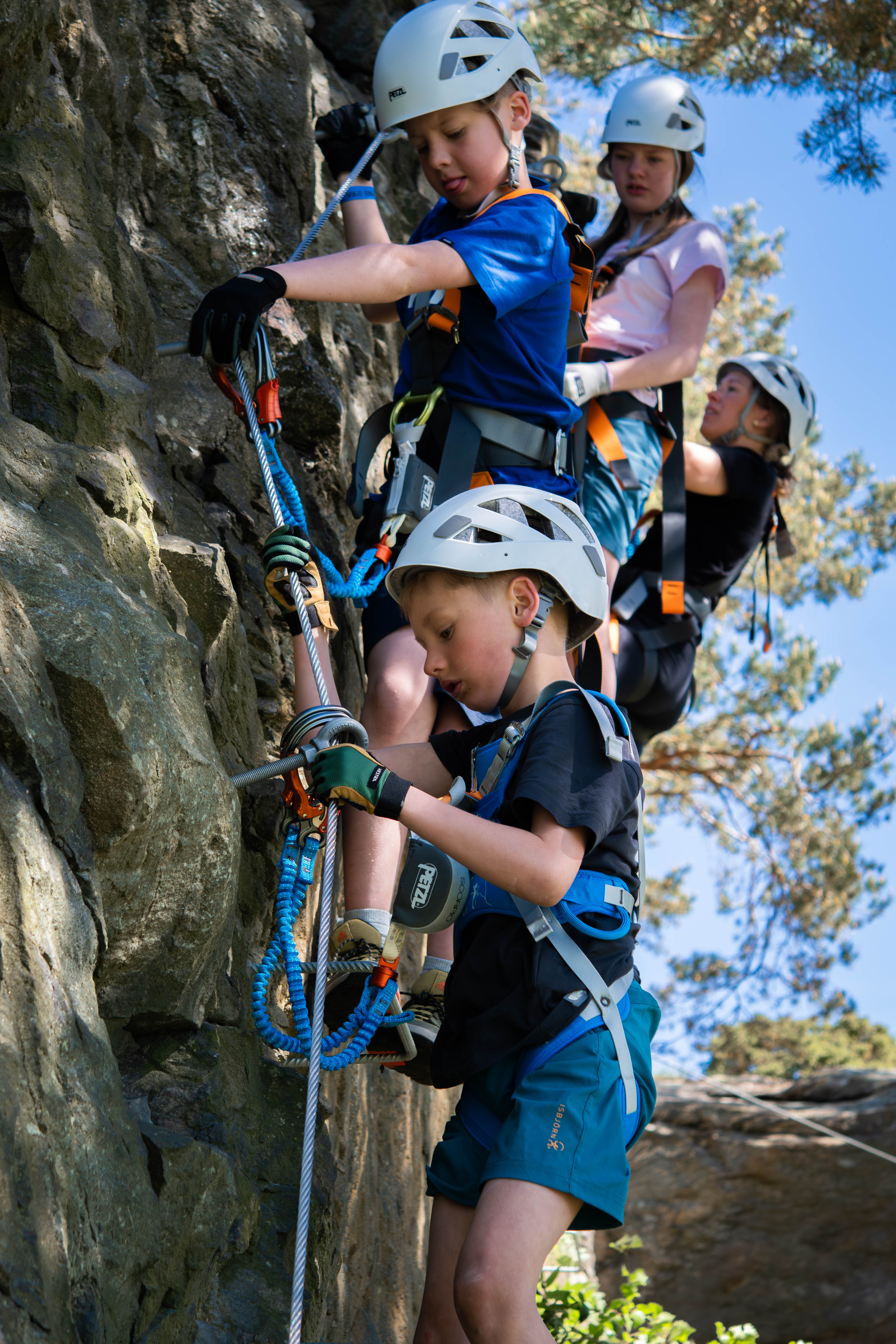 Children climbing the longest with a rock wall.