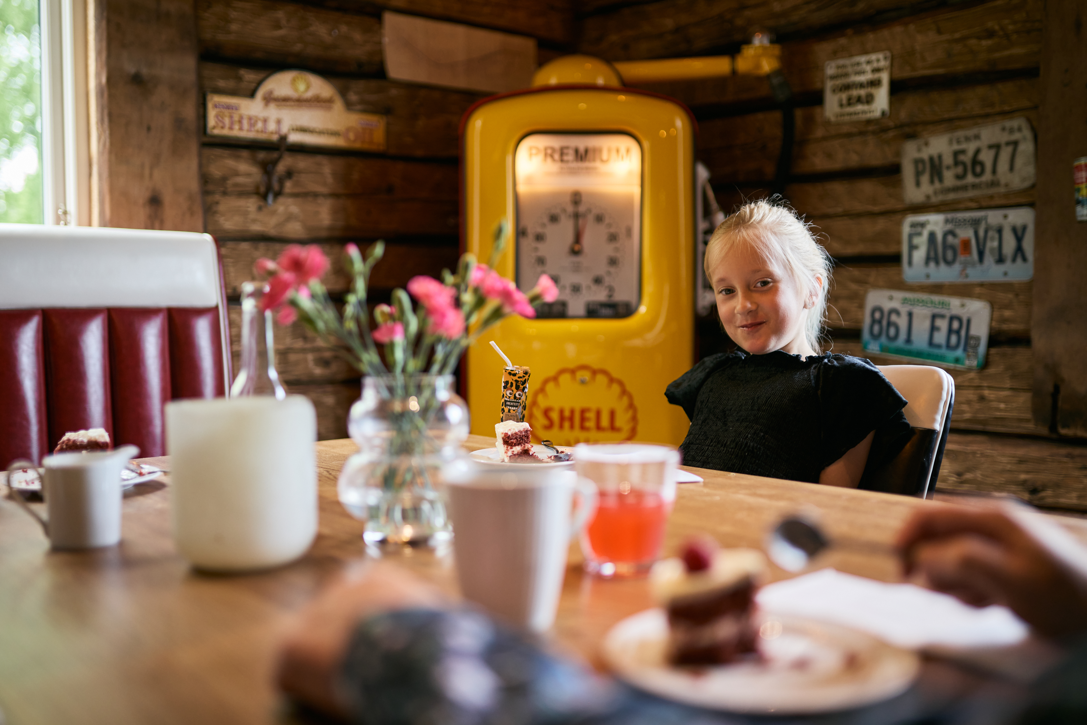 Family eating and having coffee around a table in restaurant.