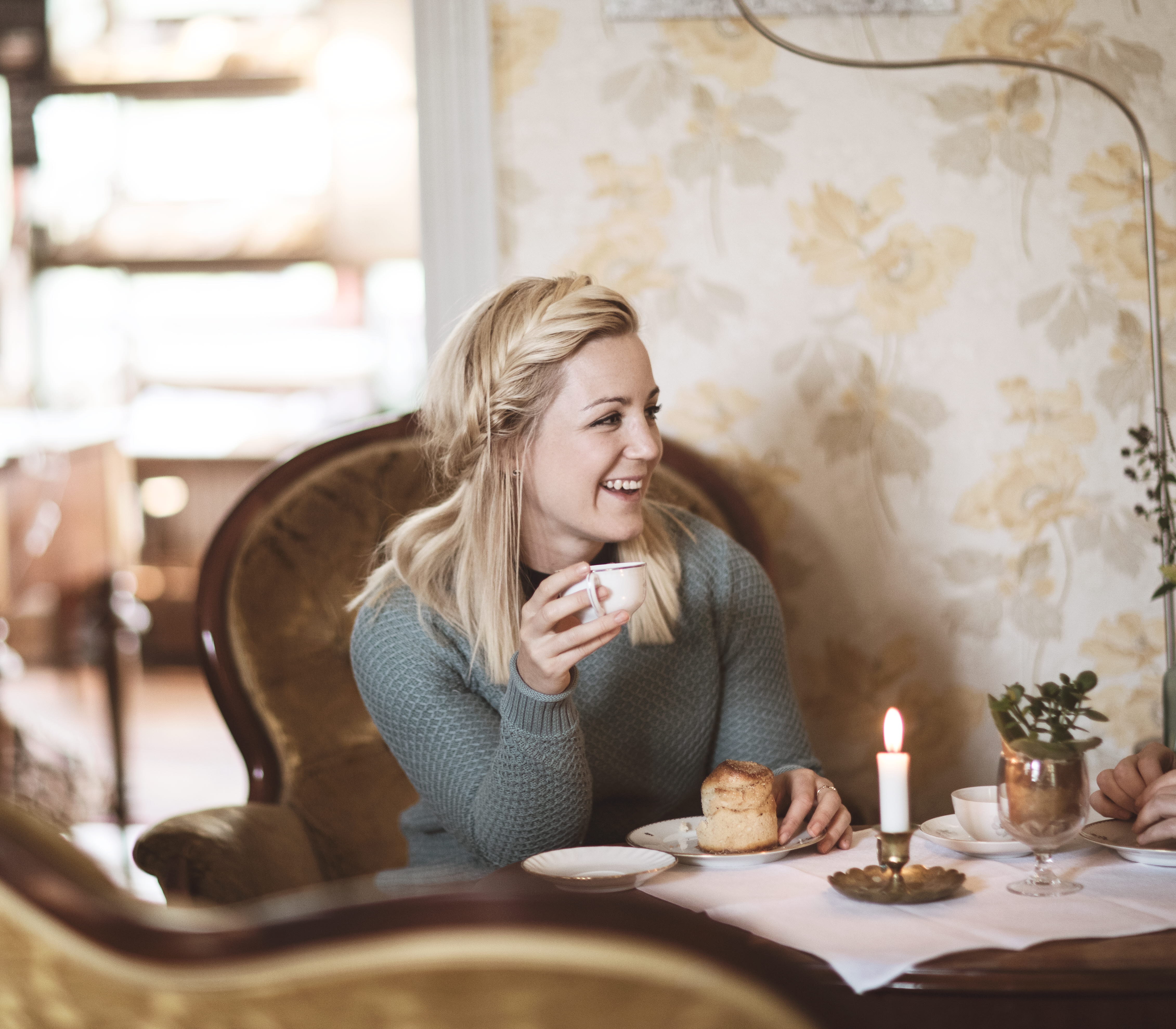 Woman enjoying cinnamon buns and coffee
