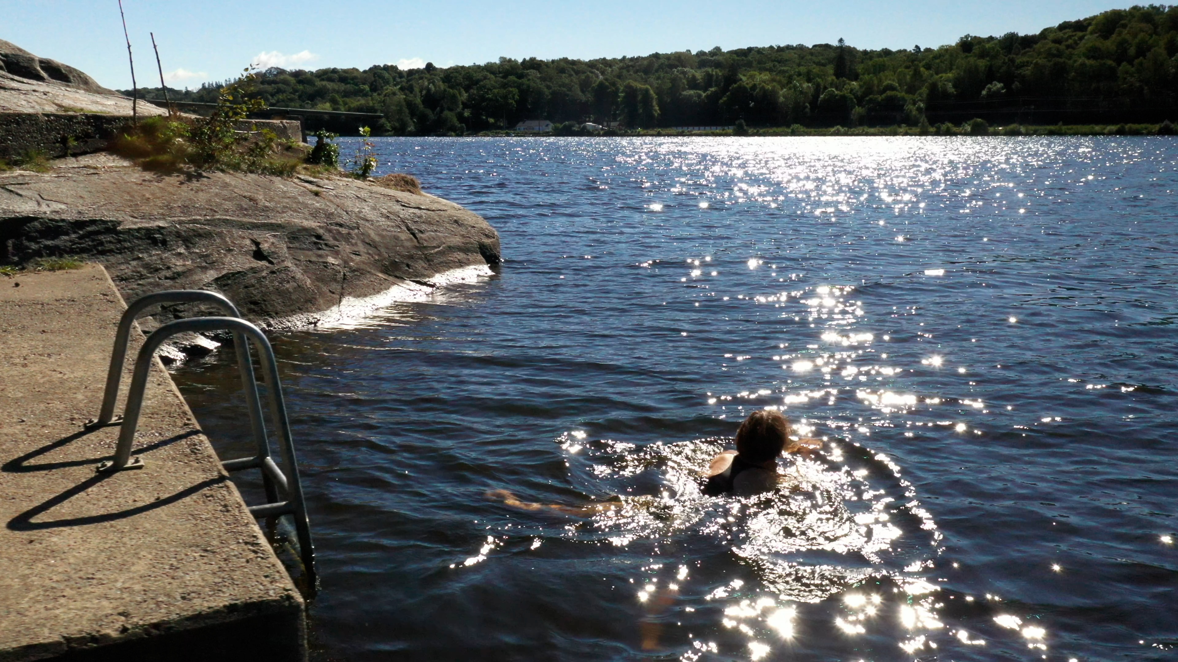 Uschi Disl swim in a lake
