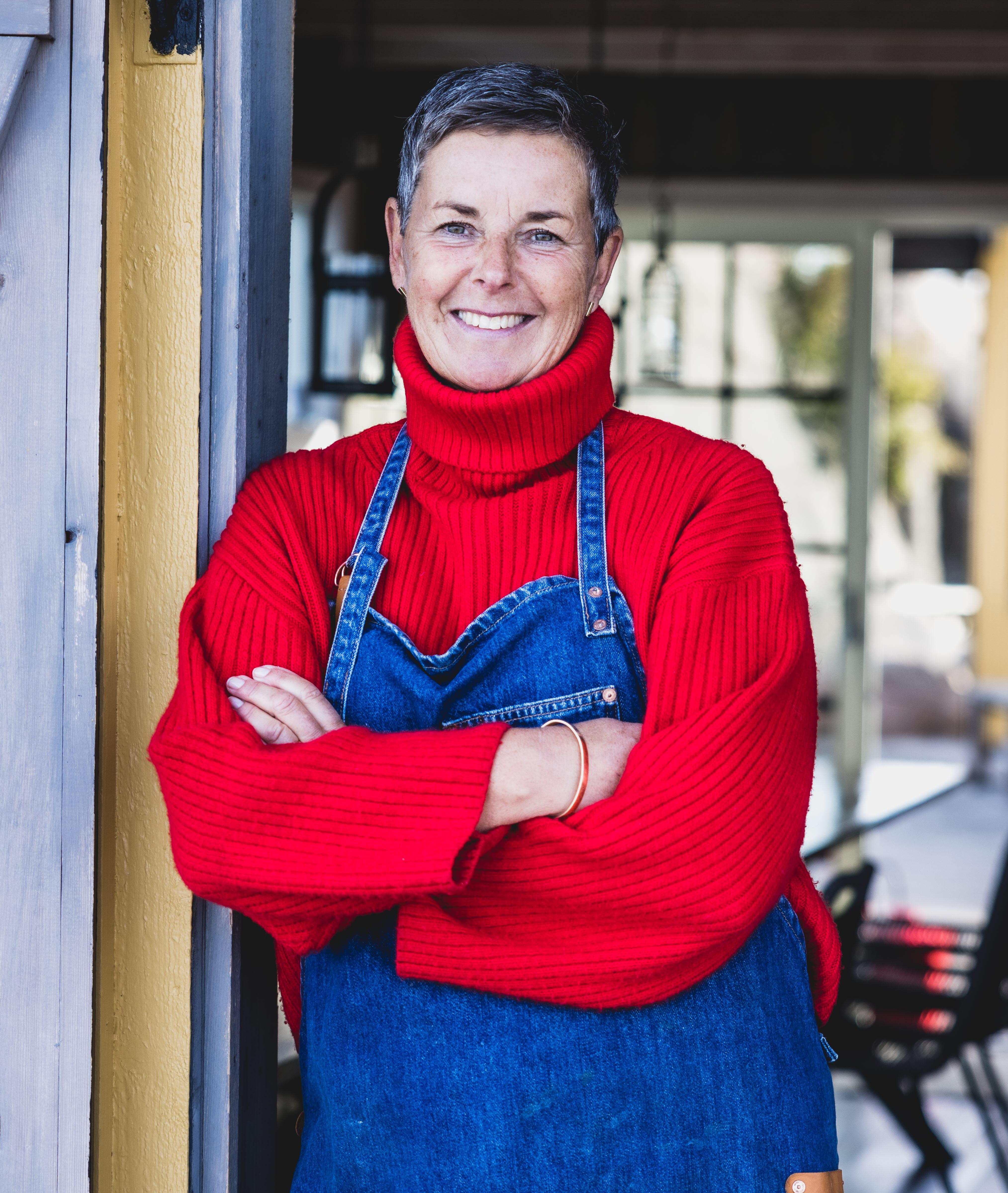 The owner standing in the entrance to Hampholmens Magasin