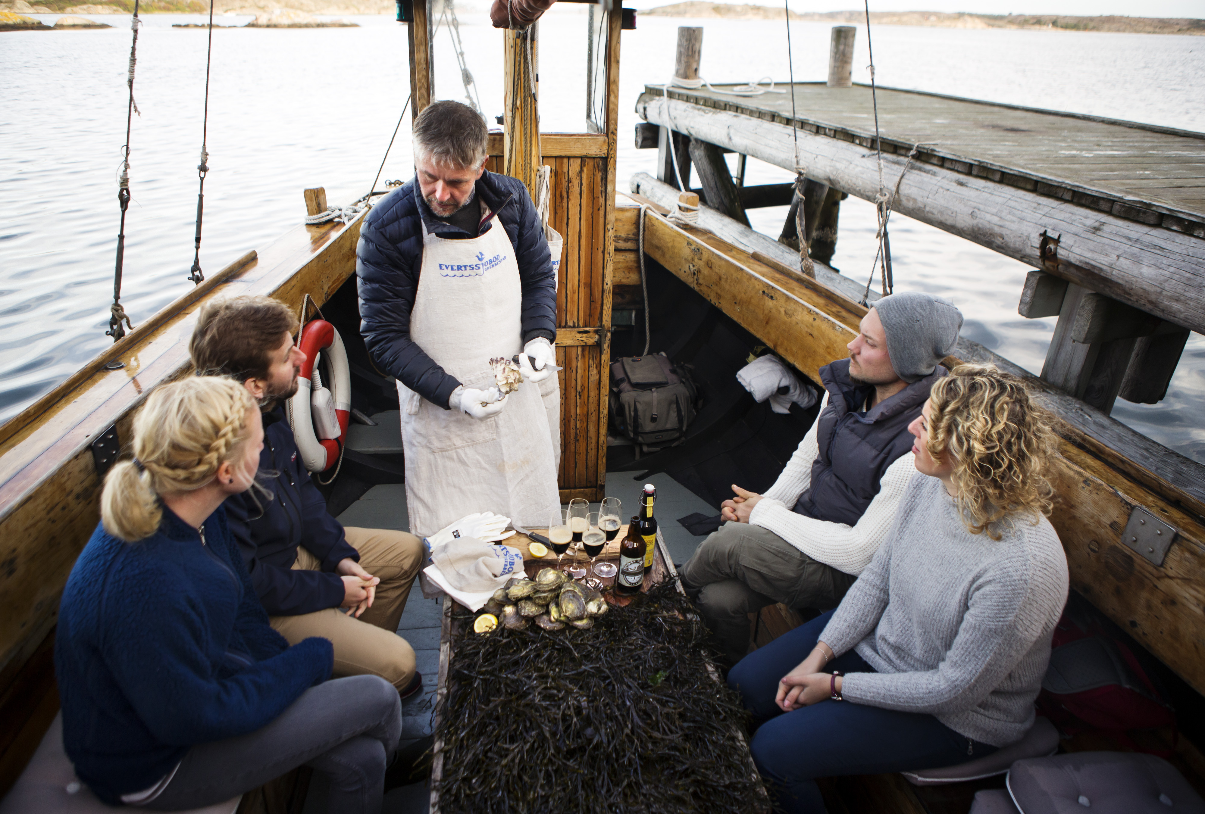 People tasting oysters on a boat