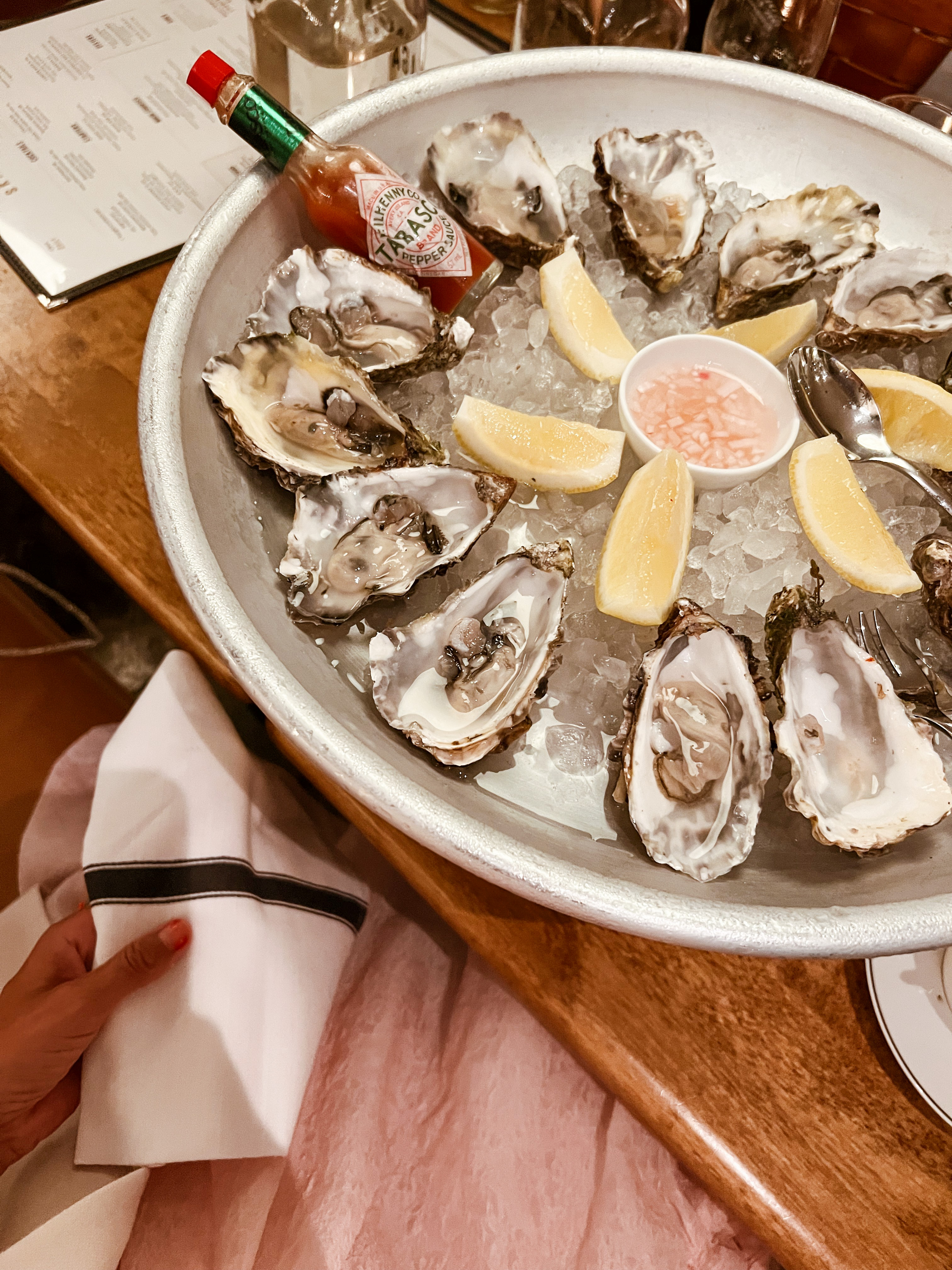 Oysters on a plate with lemon and tabasco