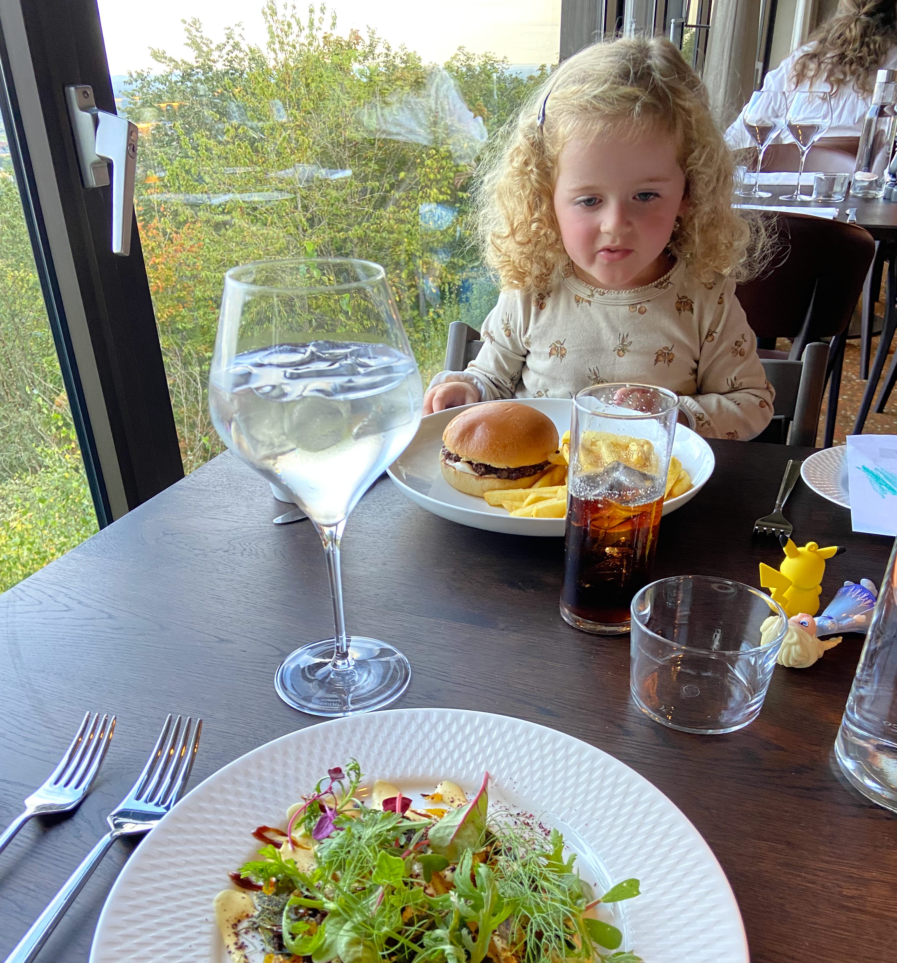 A person sitting at a table with a plate of food.