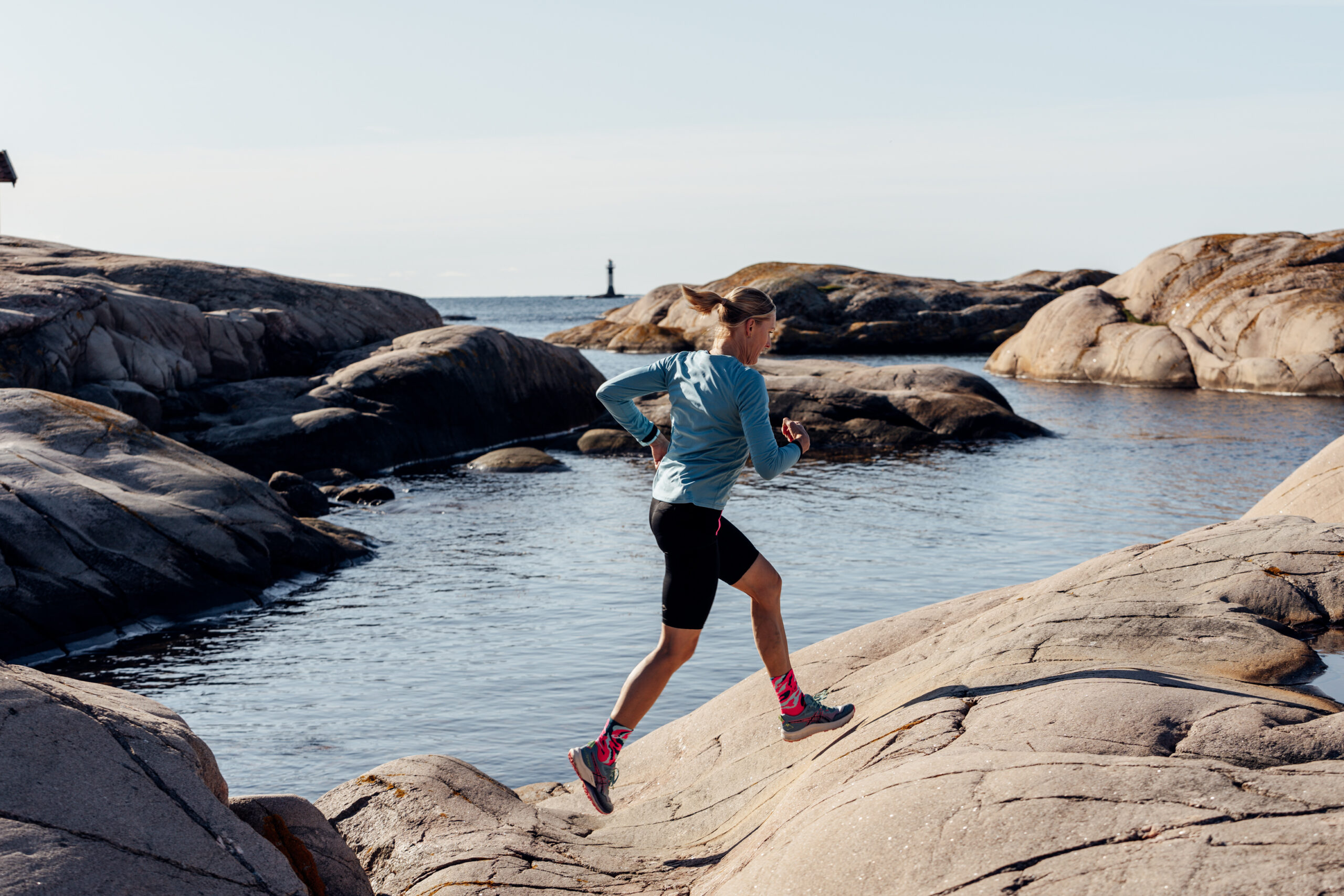 Woman running on the cliffs in Bohuslän