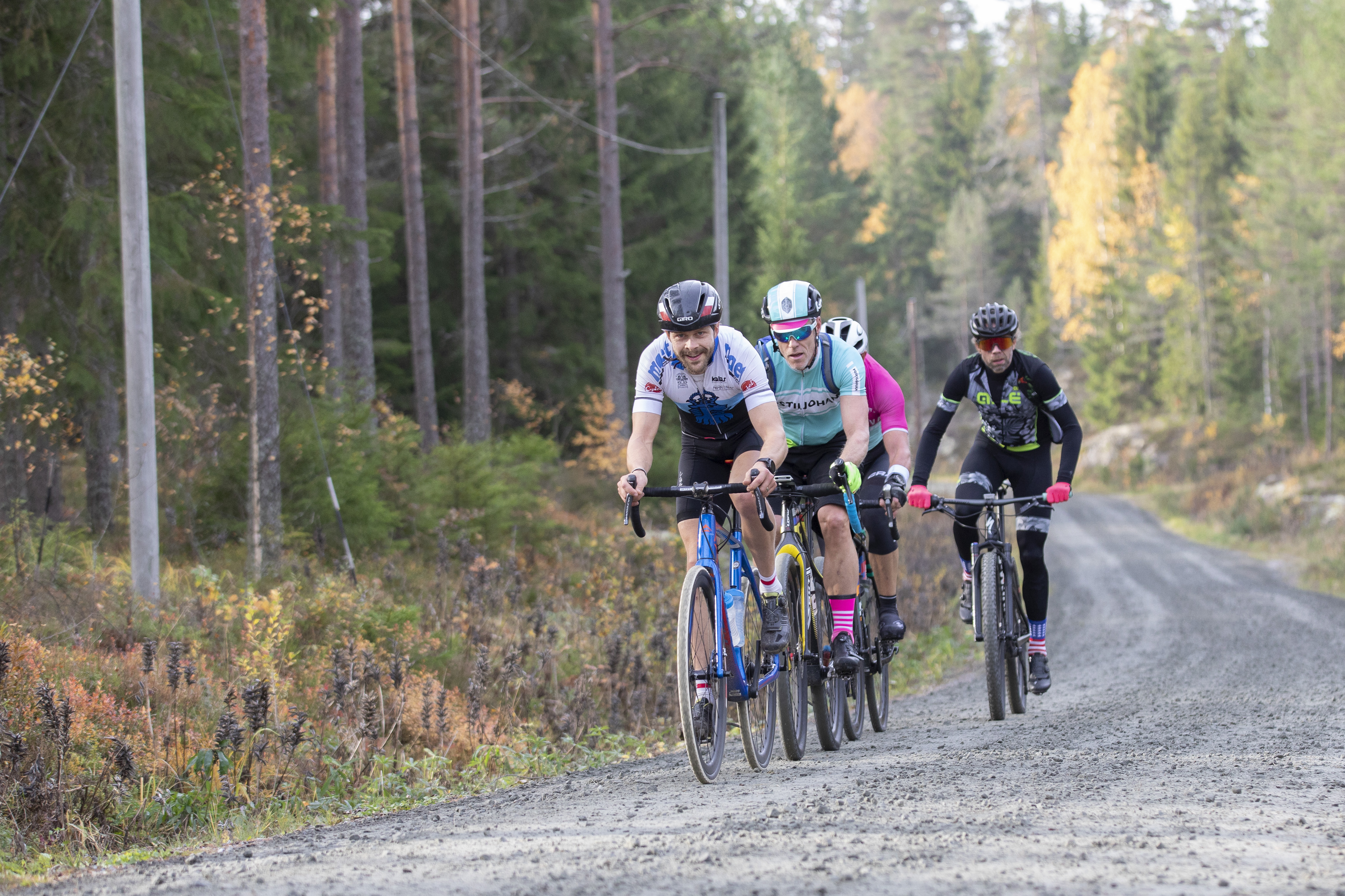 Bikers on a gravel road.