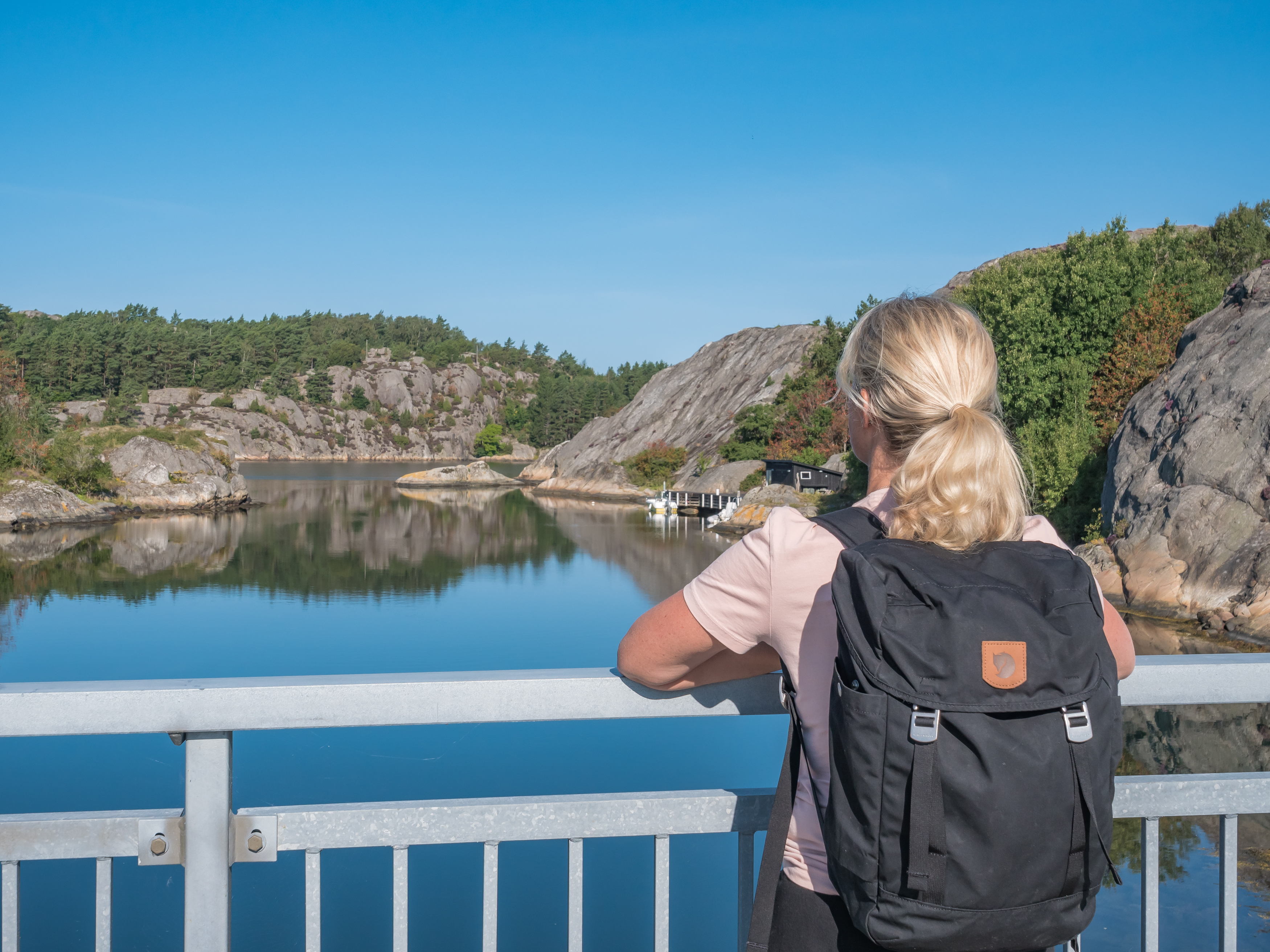 Coastal environment with rocks, blue sky and hikers.