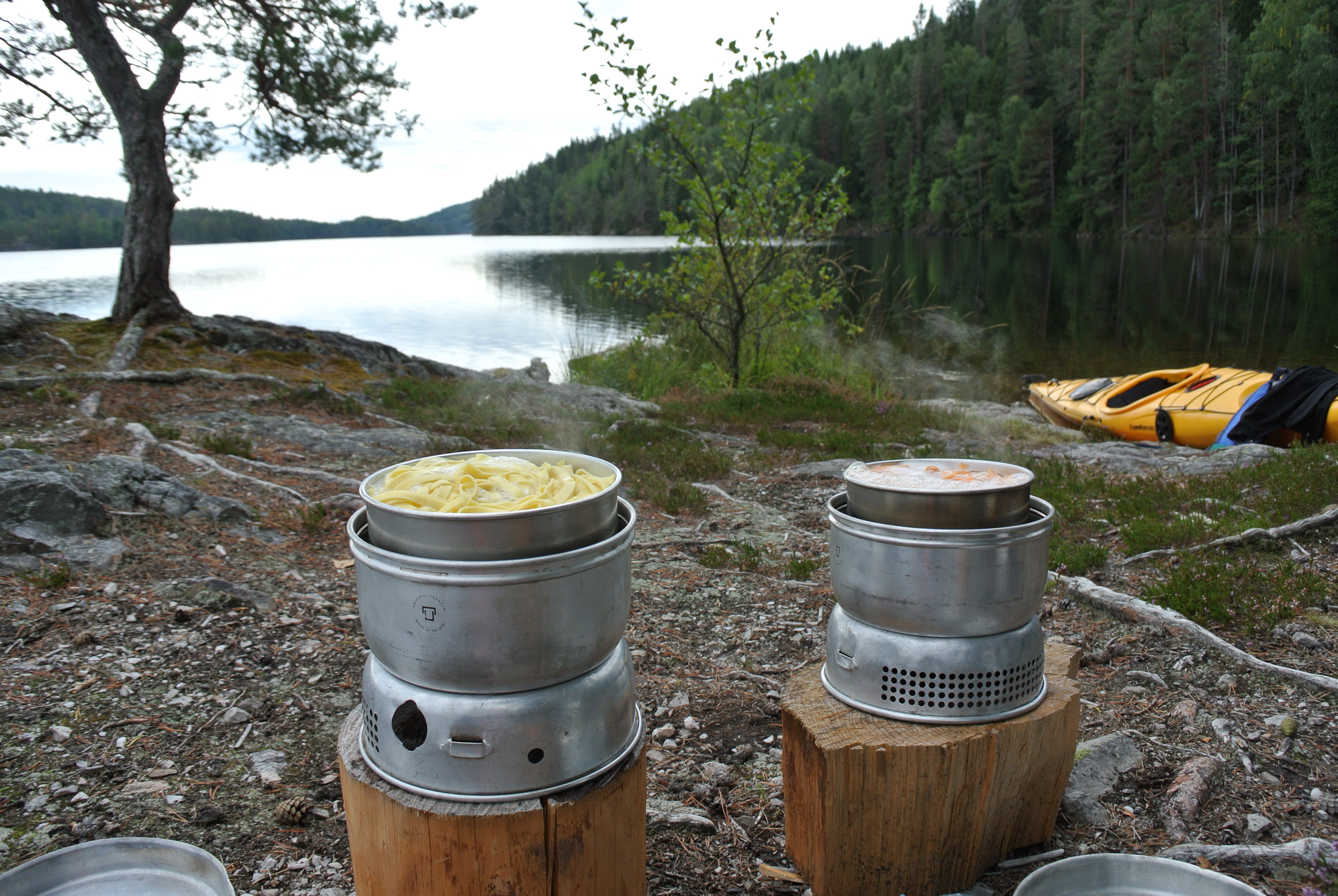 Lunch i beeing prepared on a gasstove with lake view.