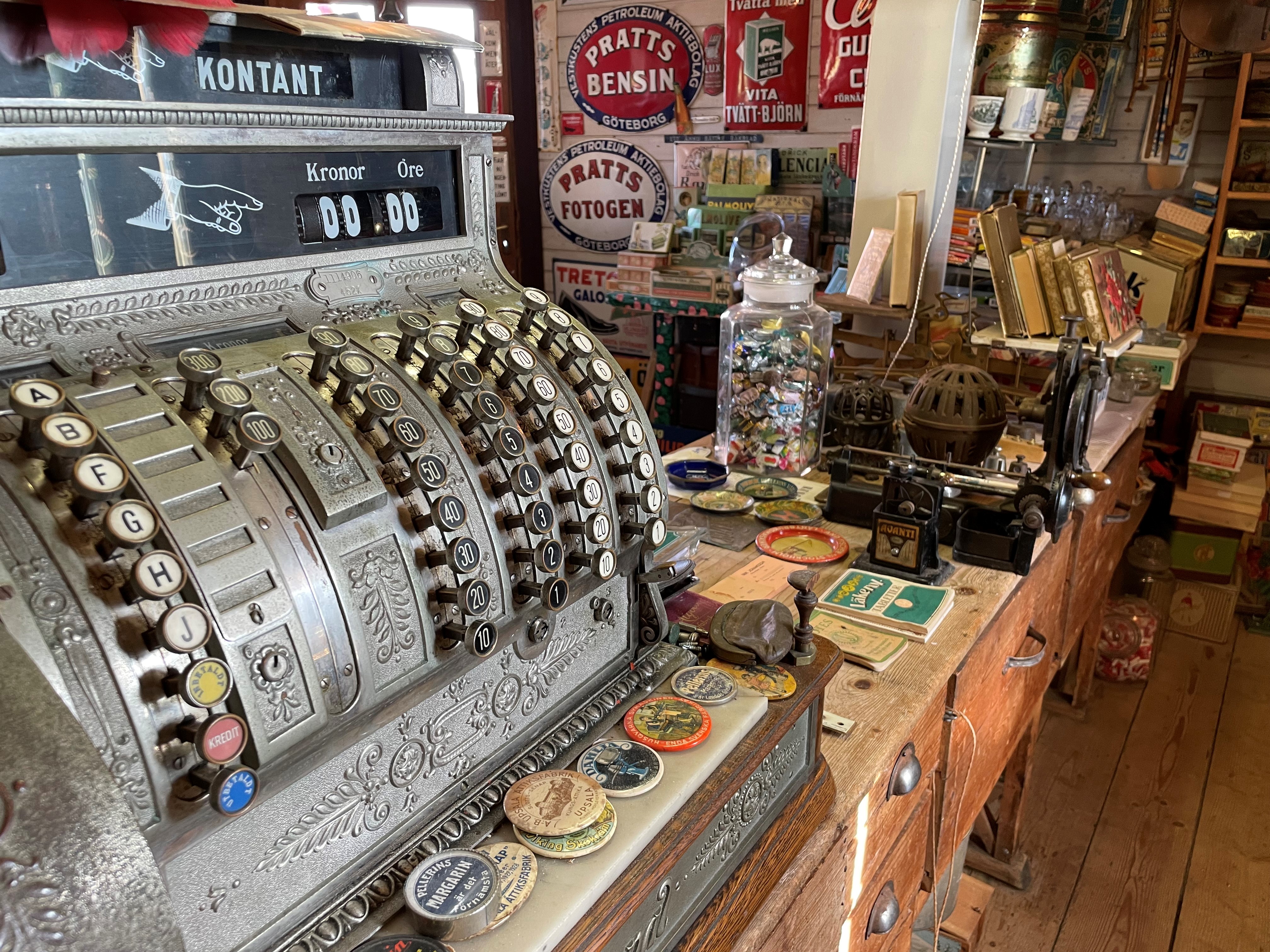 En gammaldags kassapparat och en lanthandelsdisk.