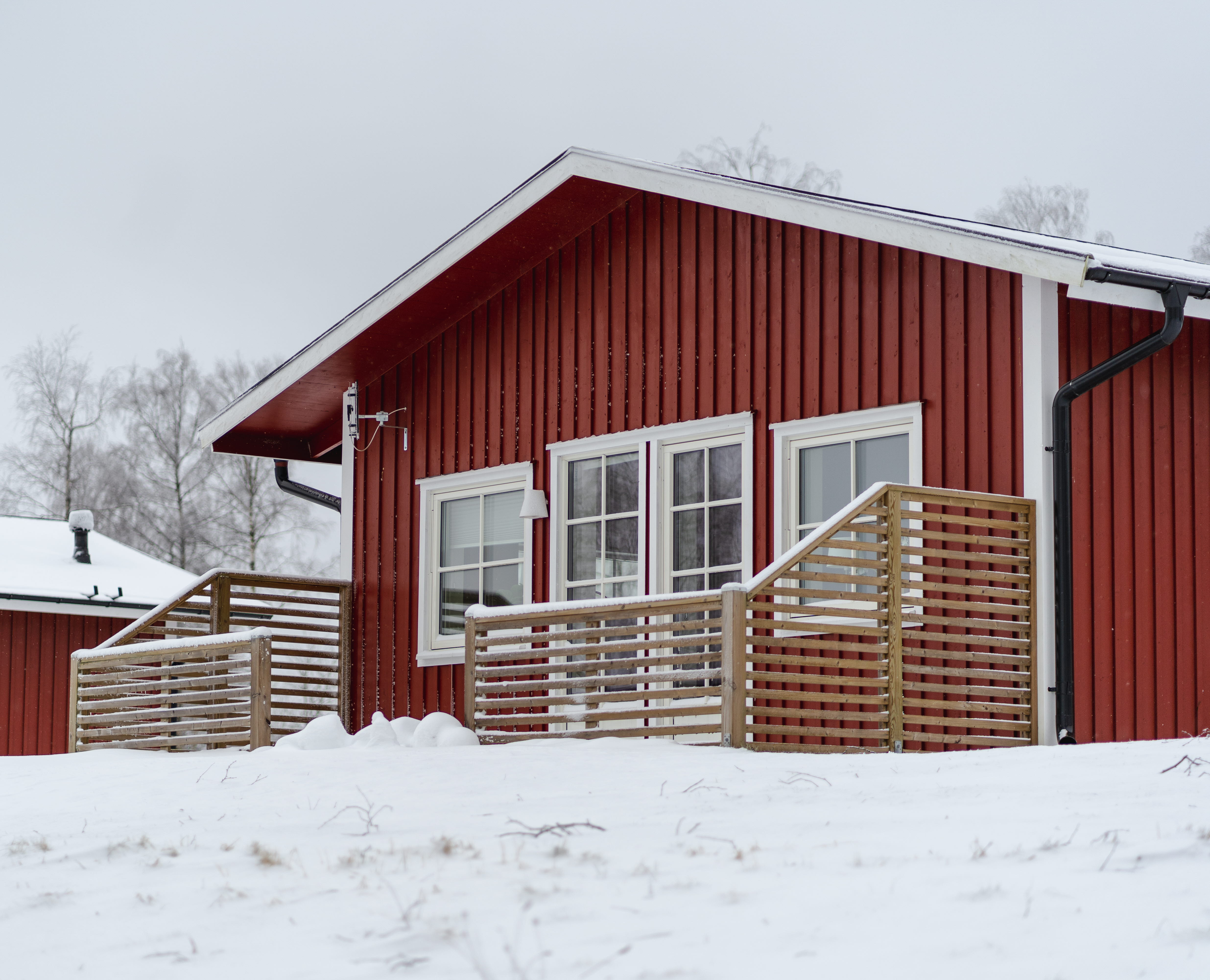 Red cottage with snow outside.