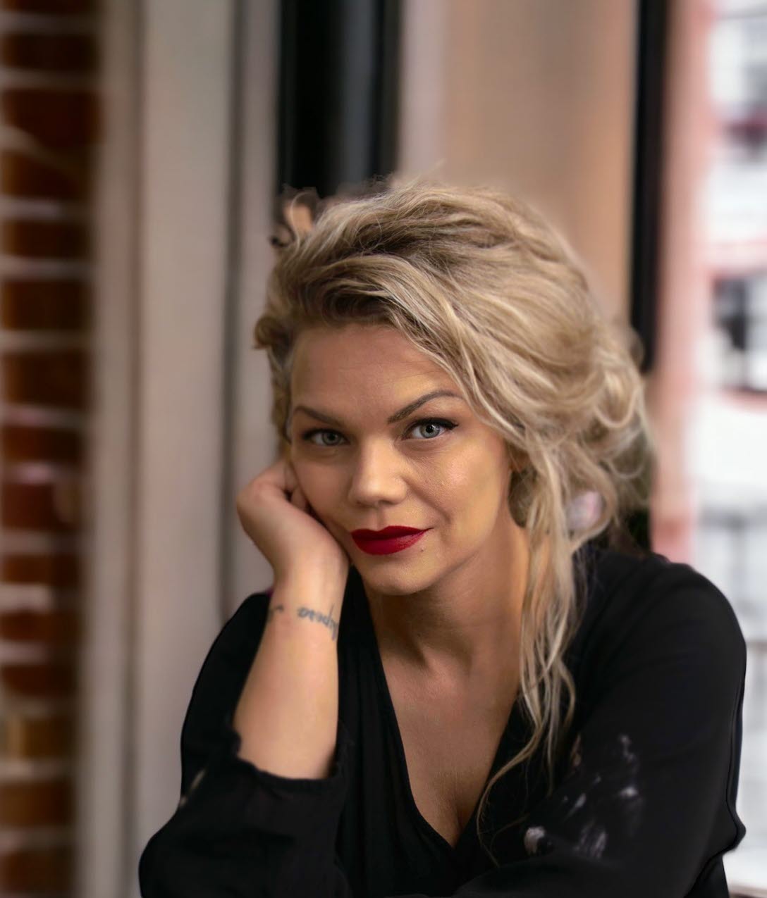 En närbild på Mercedes hon har svarta kläder och ljust hår.