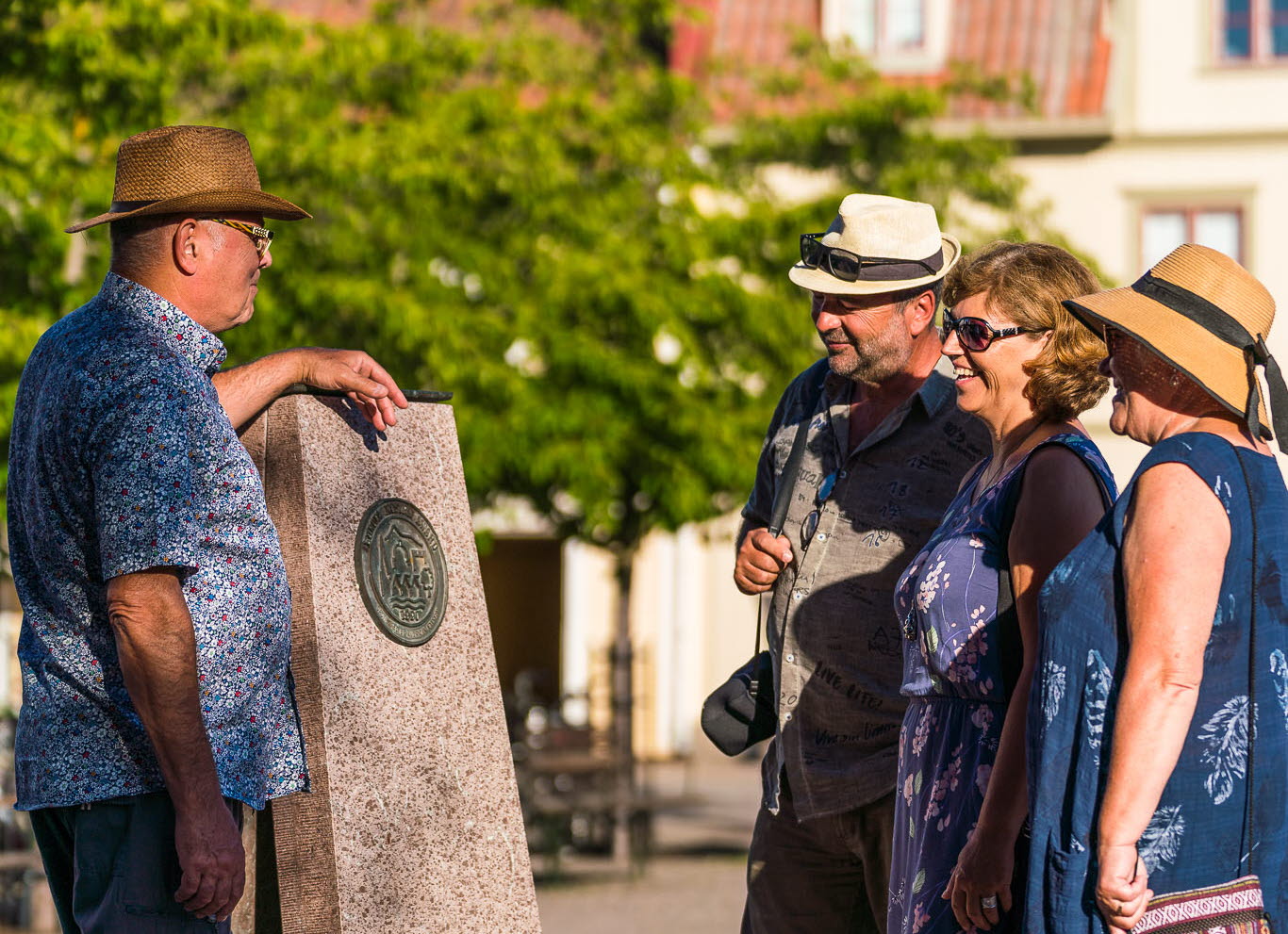 People looking at a stone sculpture in Hjo. 