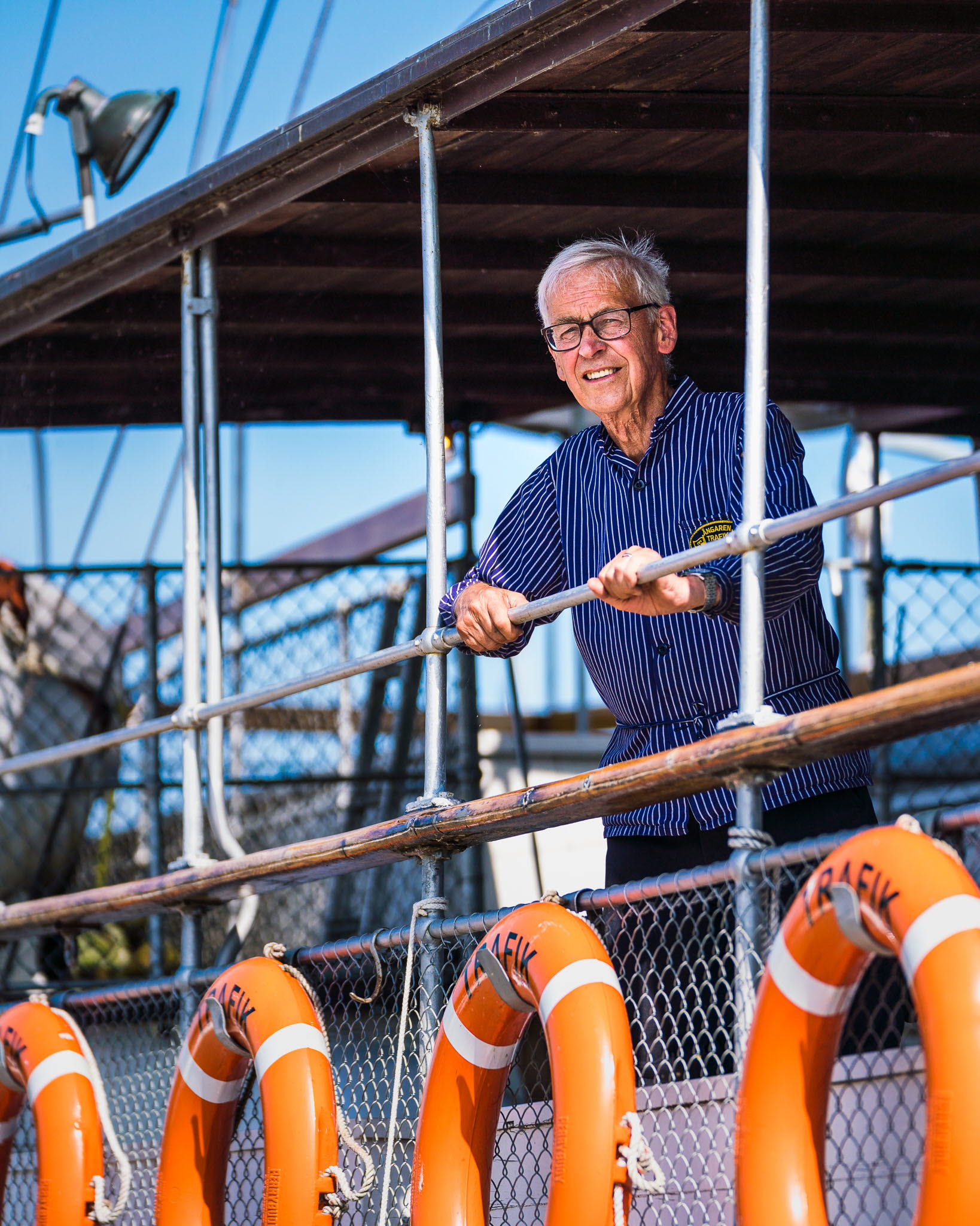Maskinist ombord på ångaren Trafik blickar ut över Hjo hamn
