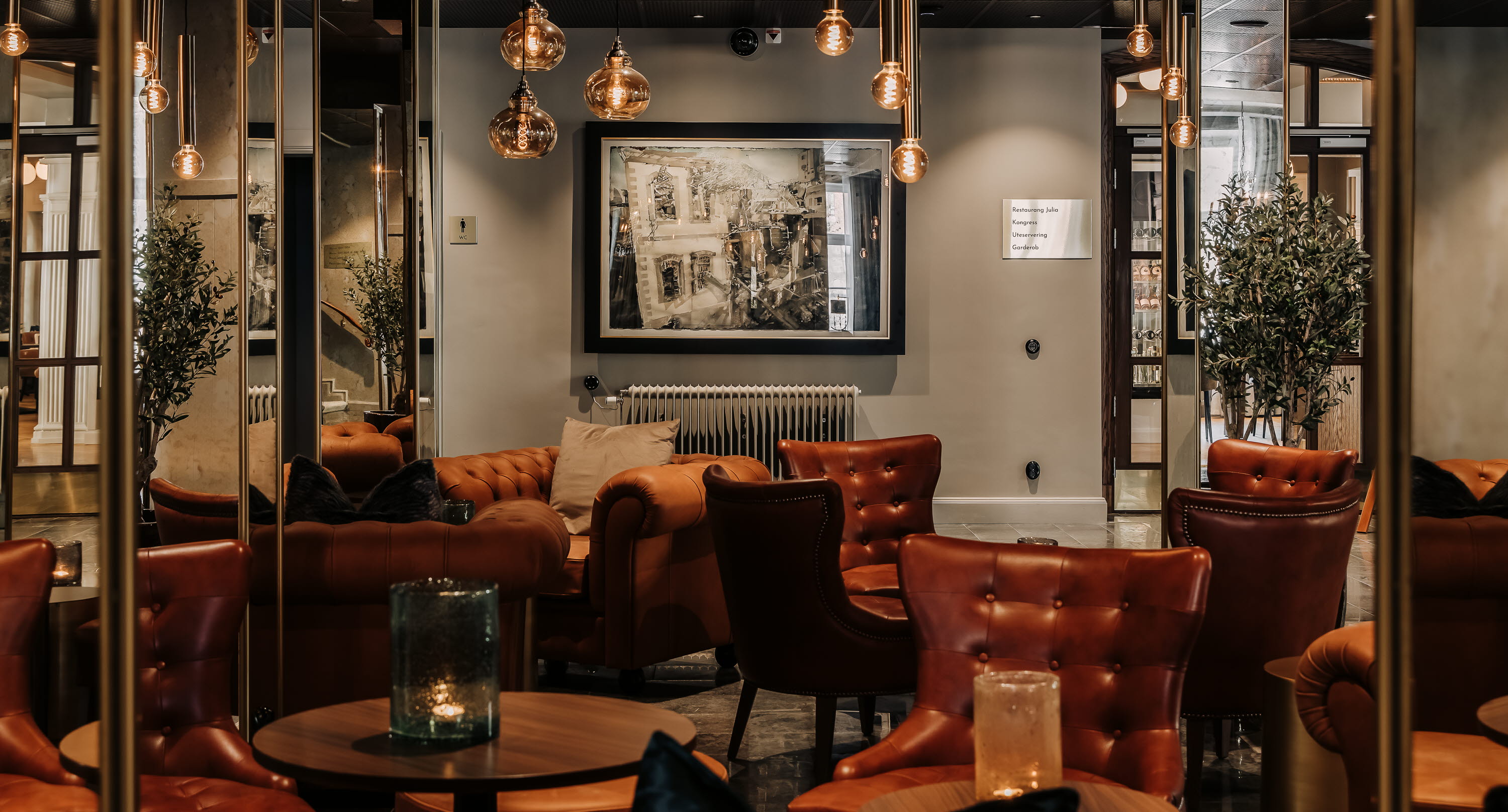 Entrance with armchairs, table and dim lighting.