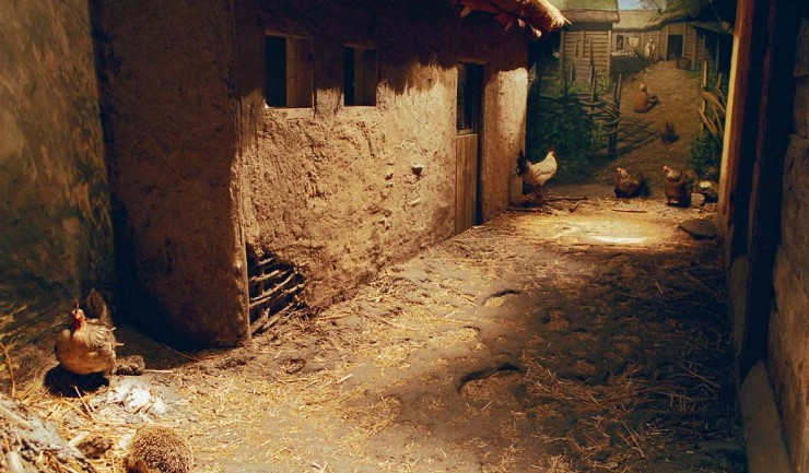 A dark room with a recreated medieval environment.