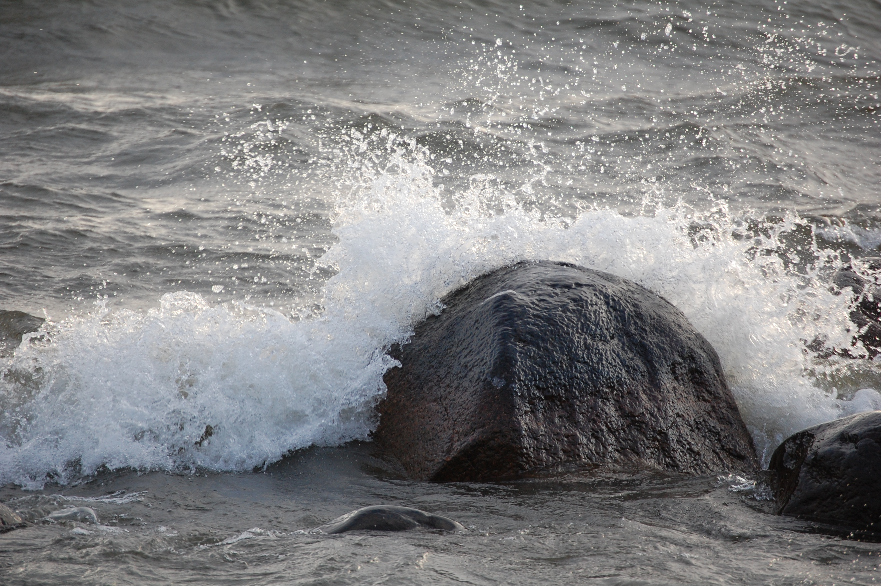 En våg slår mot en sten.