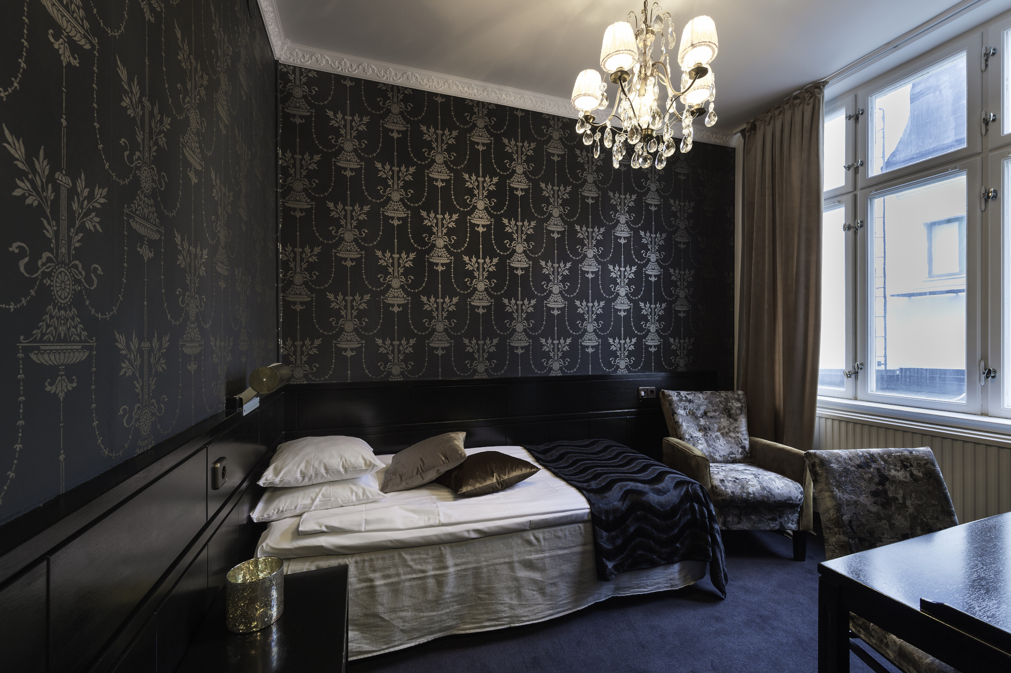 A hotel room with a bed and a window