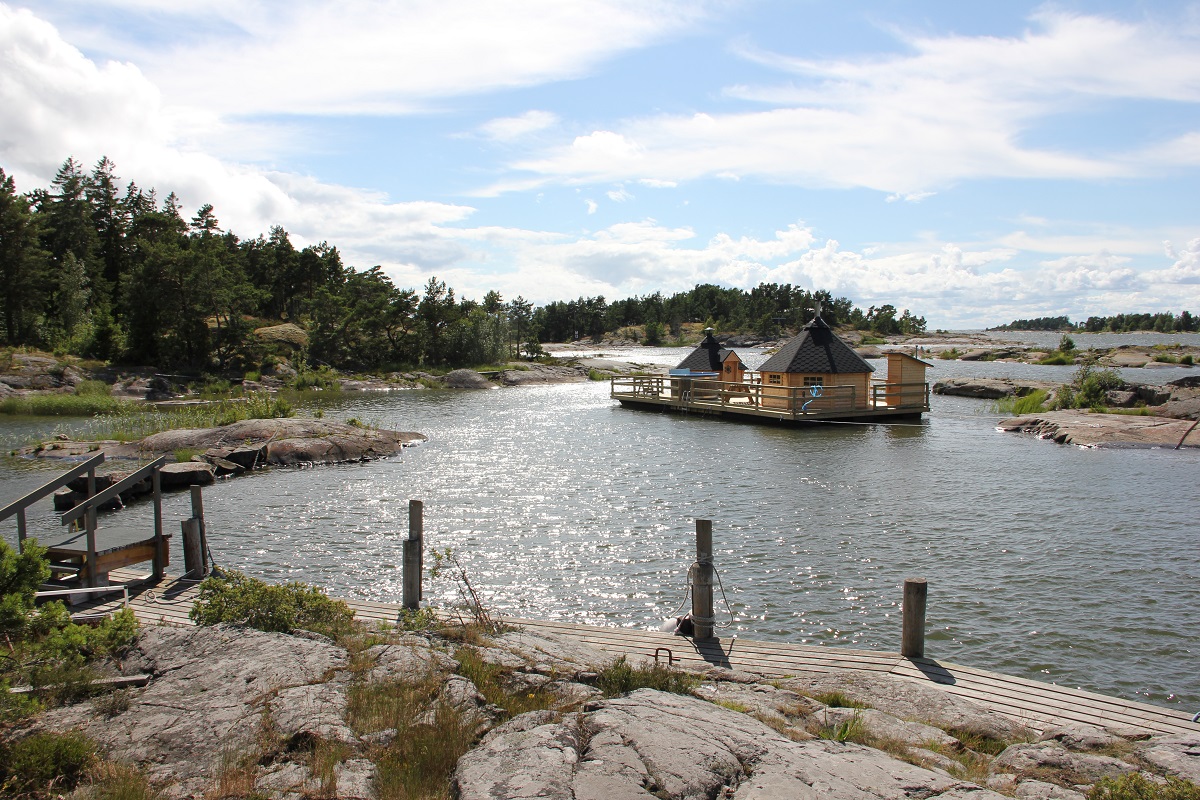 A beautiful sauna raft in the archipelago It is a sunny summer day.