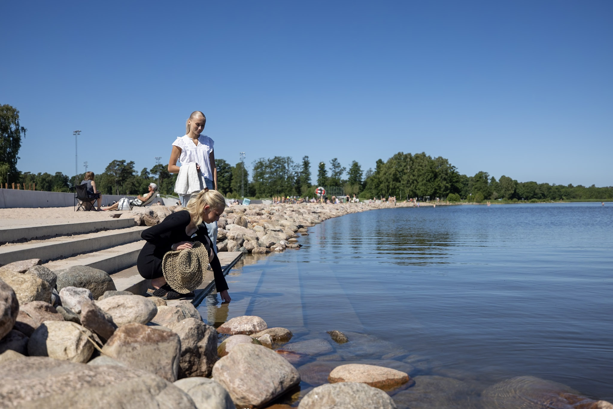 Girl feeling the water at a beach.