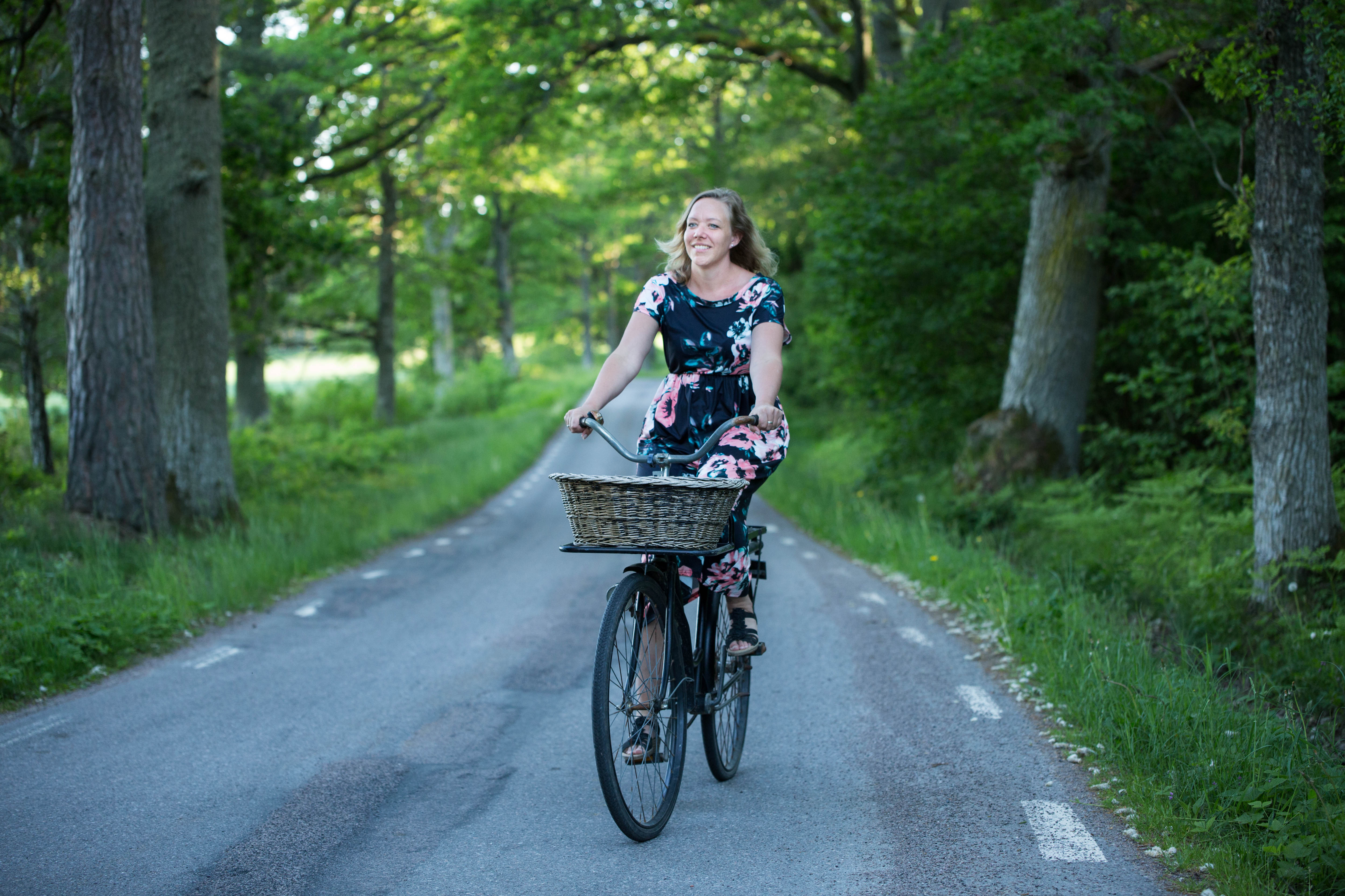 Girl on bicykle on countryroad.