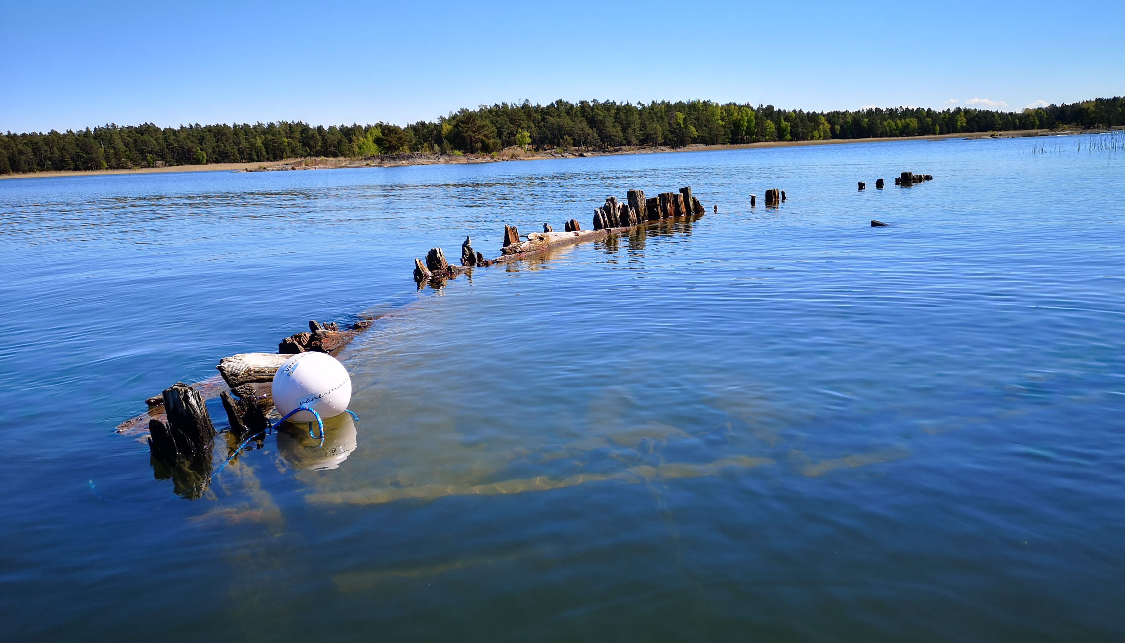 A ship wreck visible on the surface of the water
