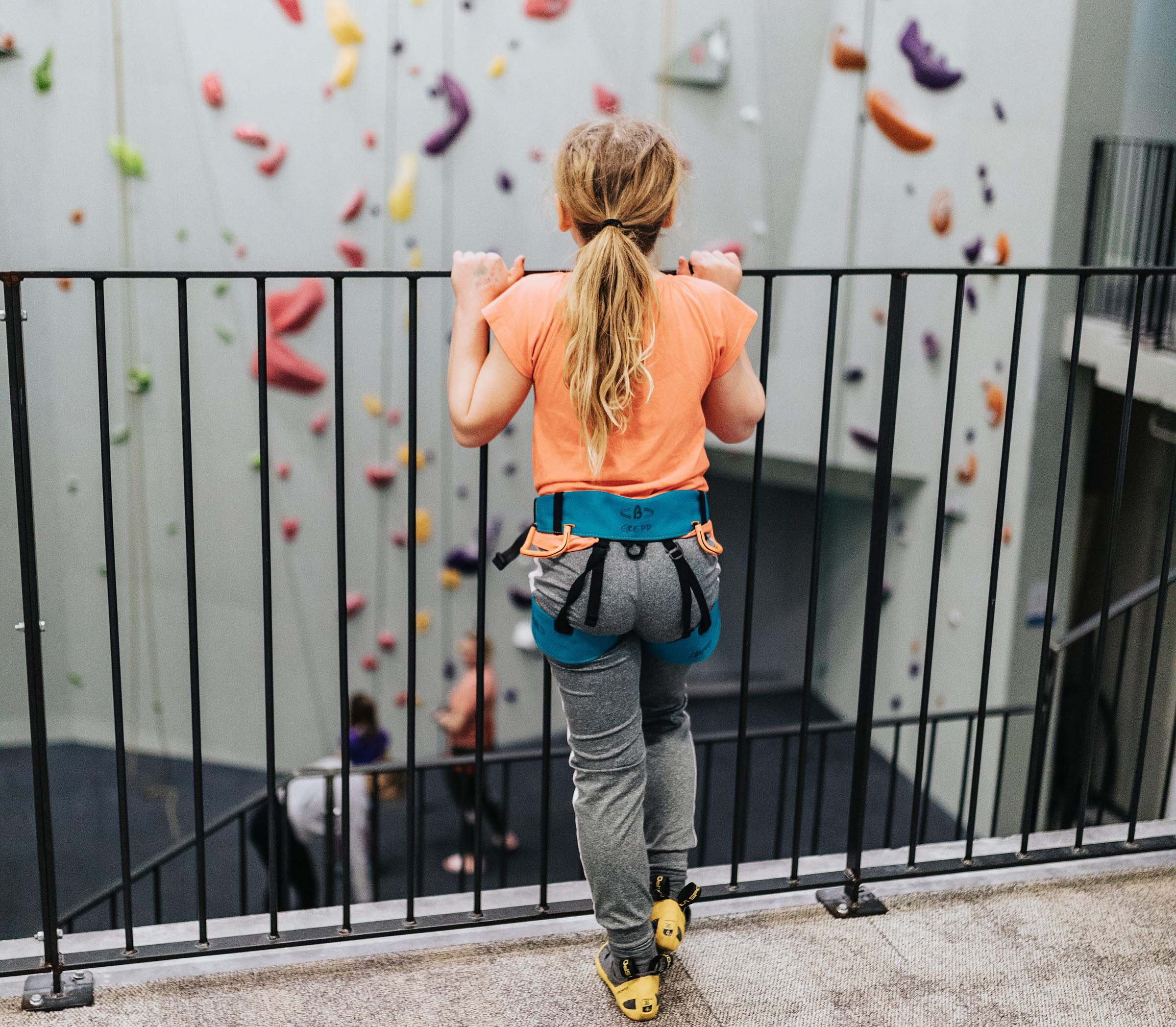 Flicka vid klättervägg