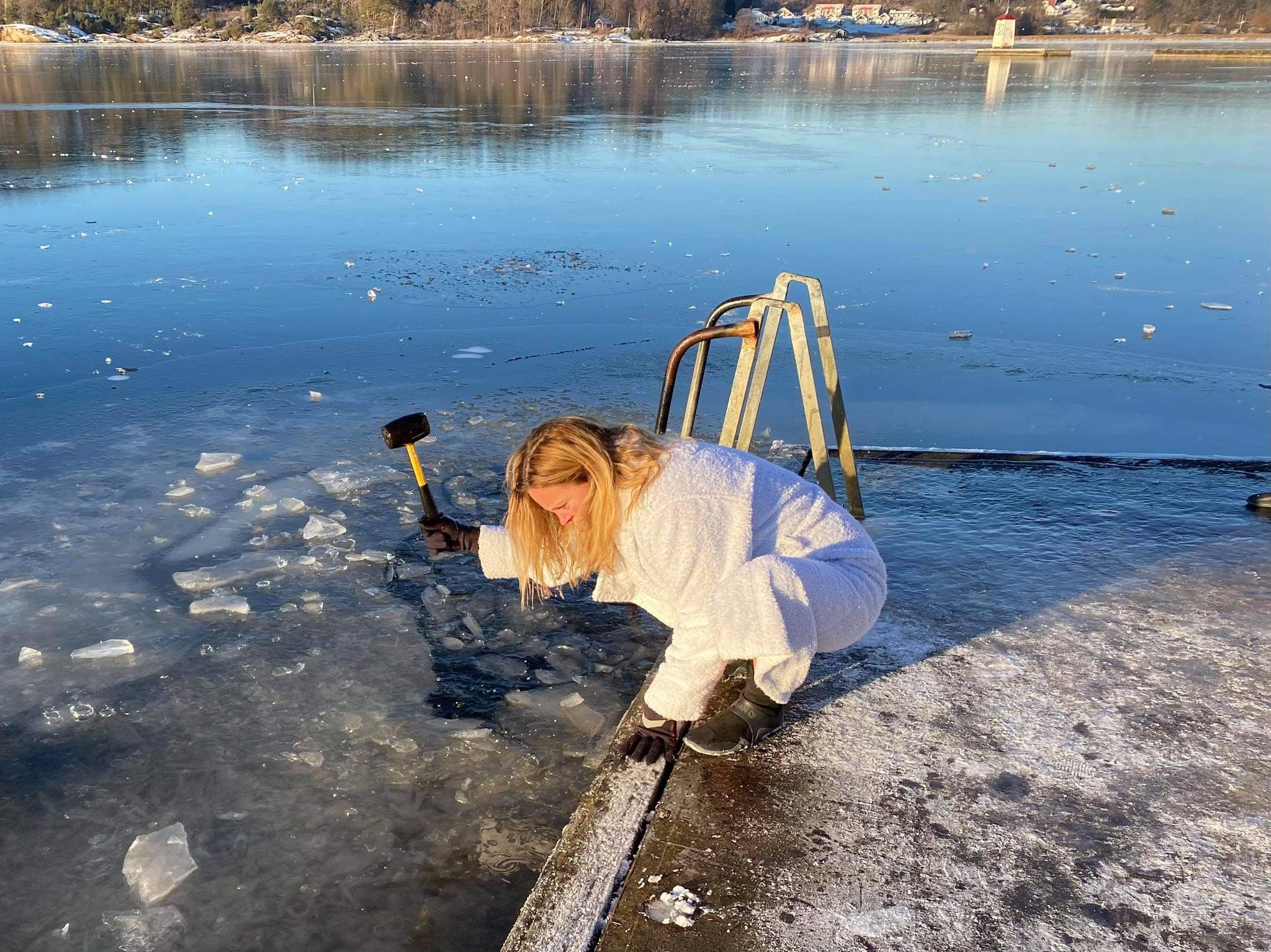 Women using hammer to break ice 