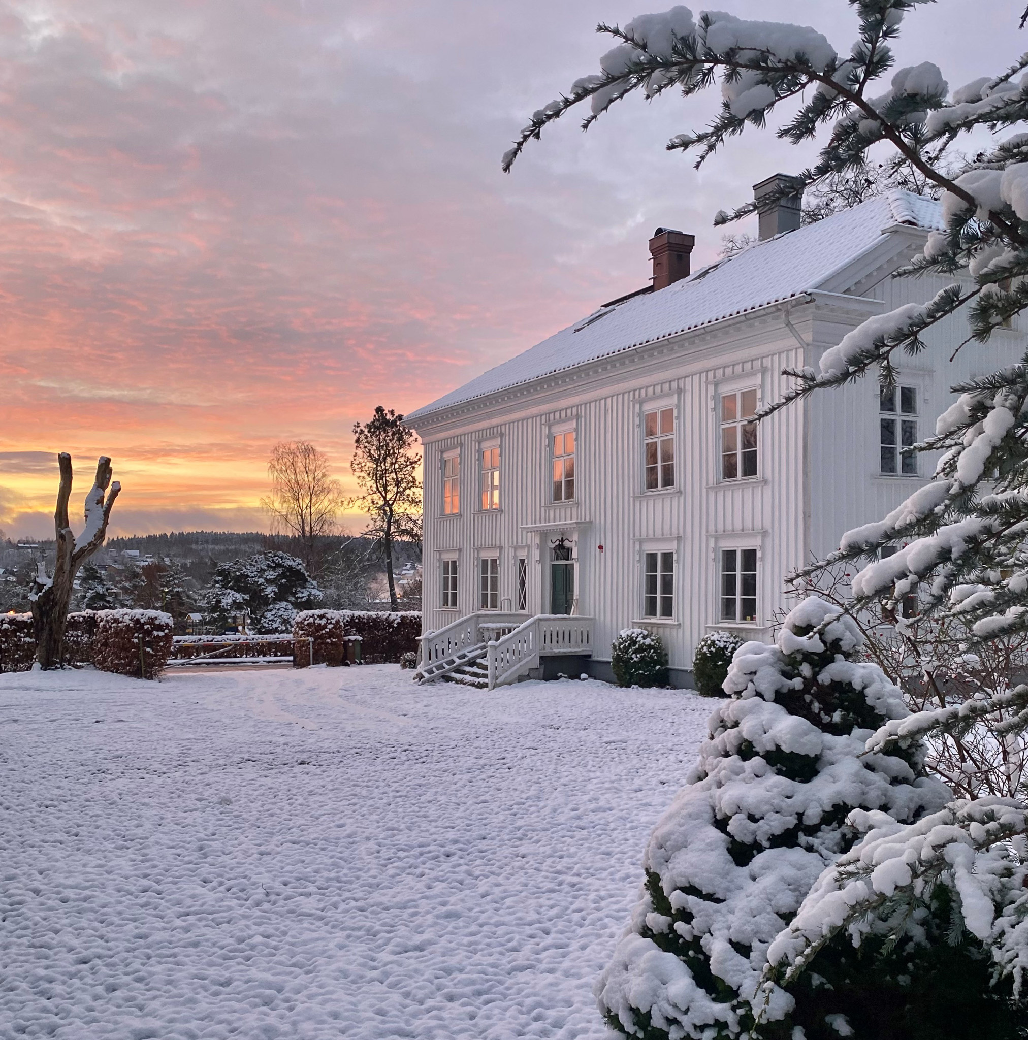 En bild på en förläggargård i vinterlandskap.