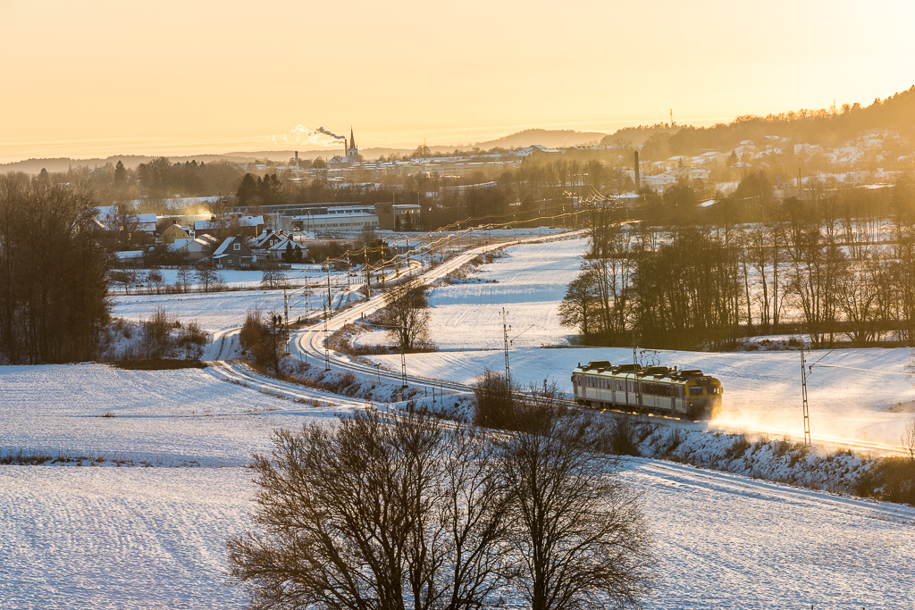 Ett tåg susar fram genom öppna, vintriga landskap.