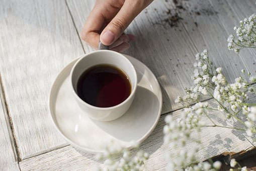 Photo of a cup of coffee standing on a table.