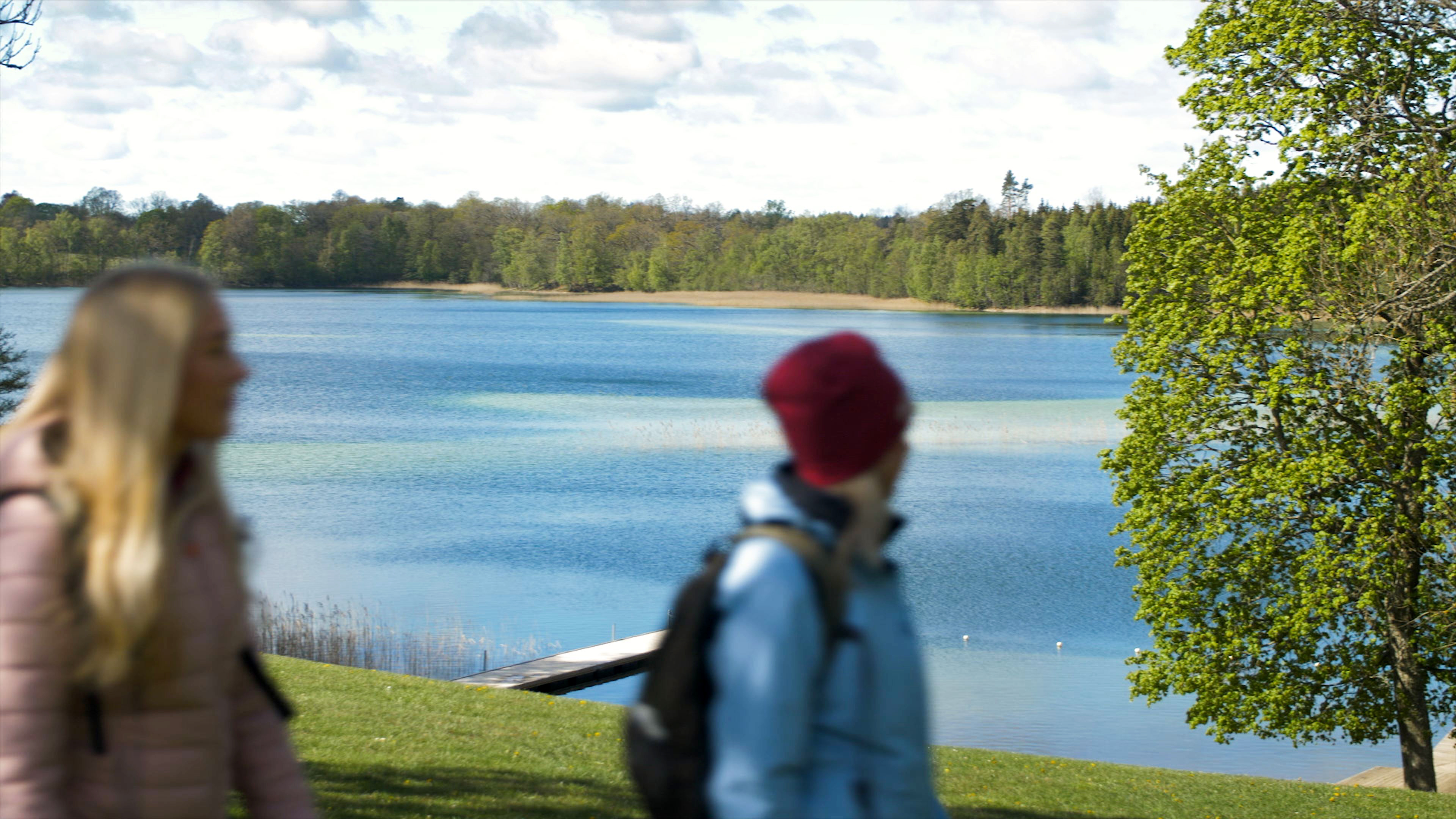 Two hikers at the close to the small beach at lake Flämsjön