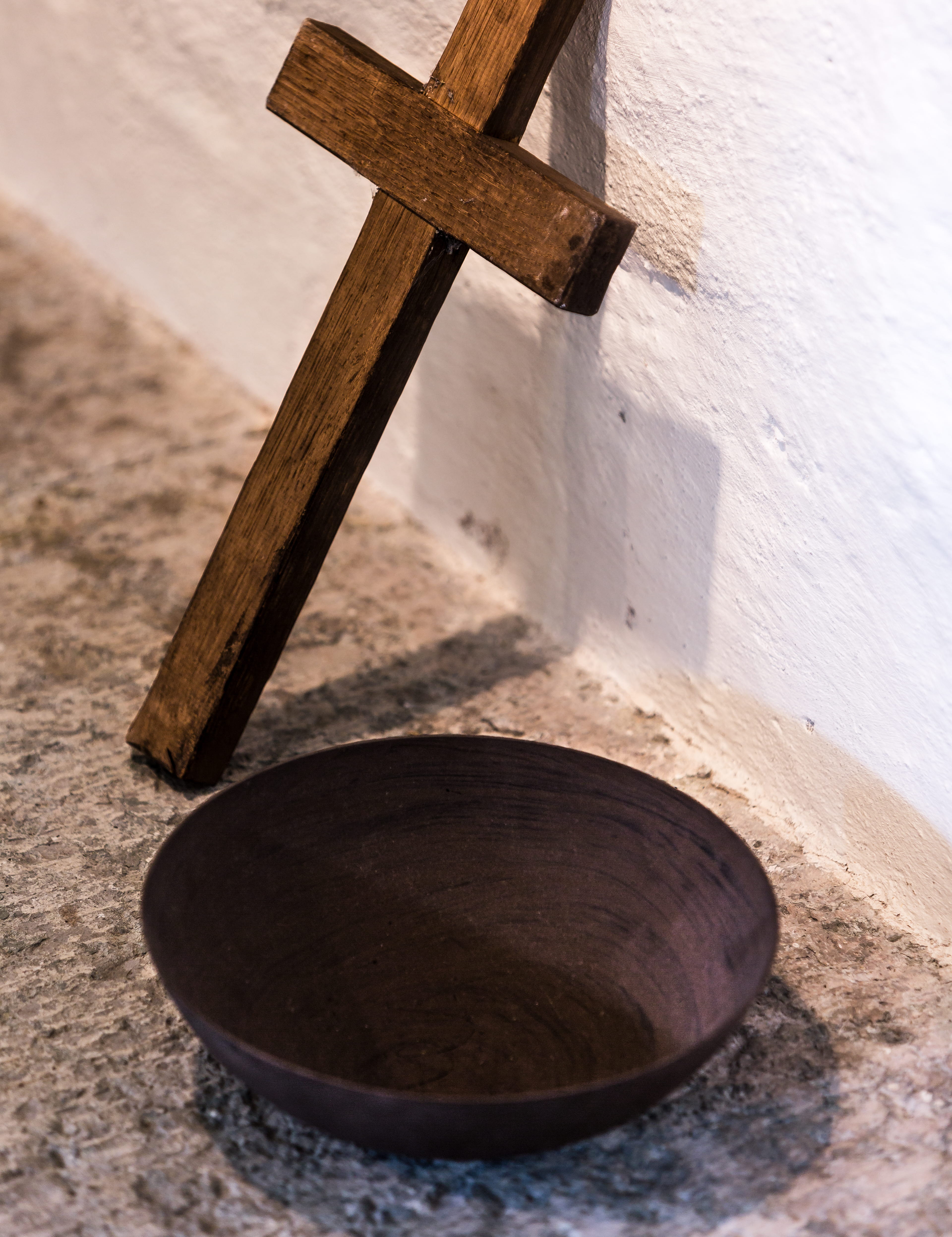 Ett träkors och en träskål.