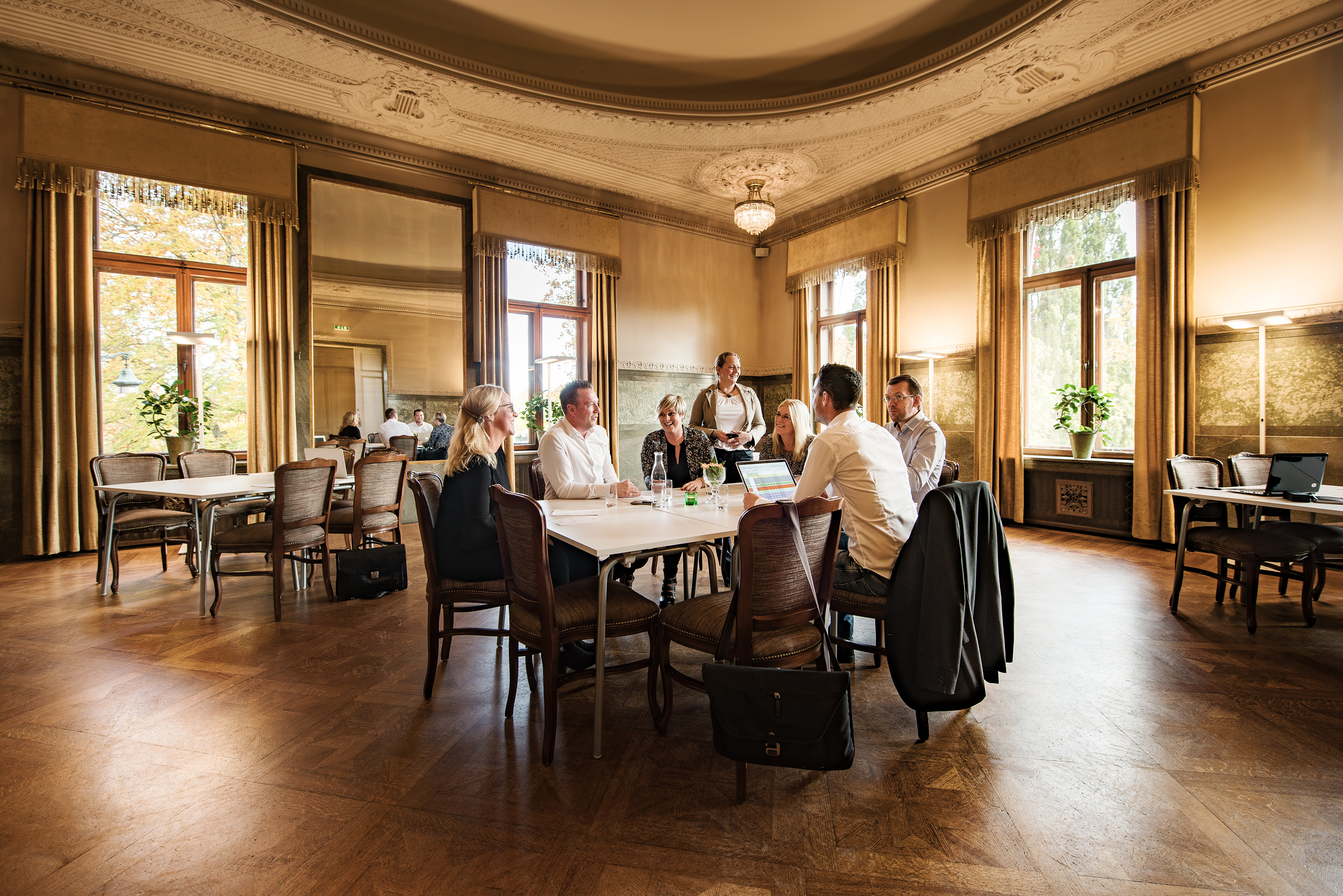 A large room with chairs where people sit and talk
