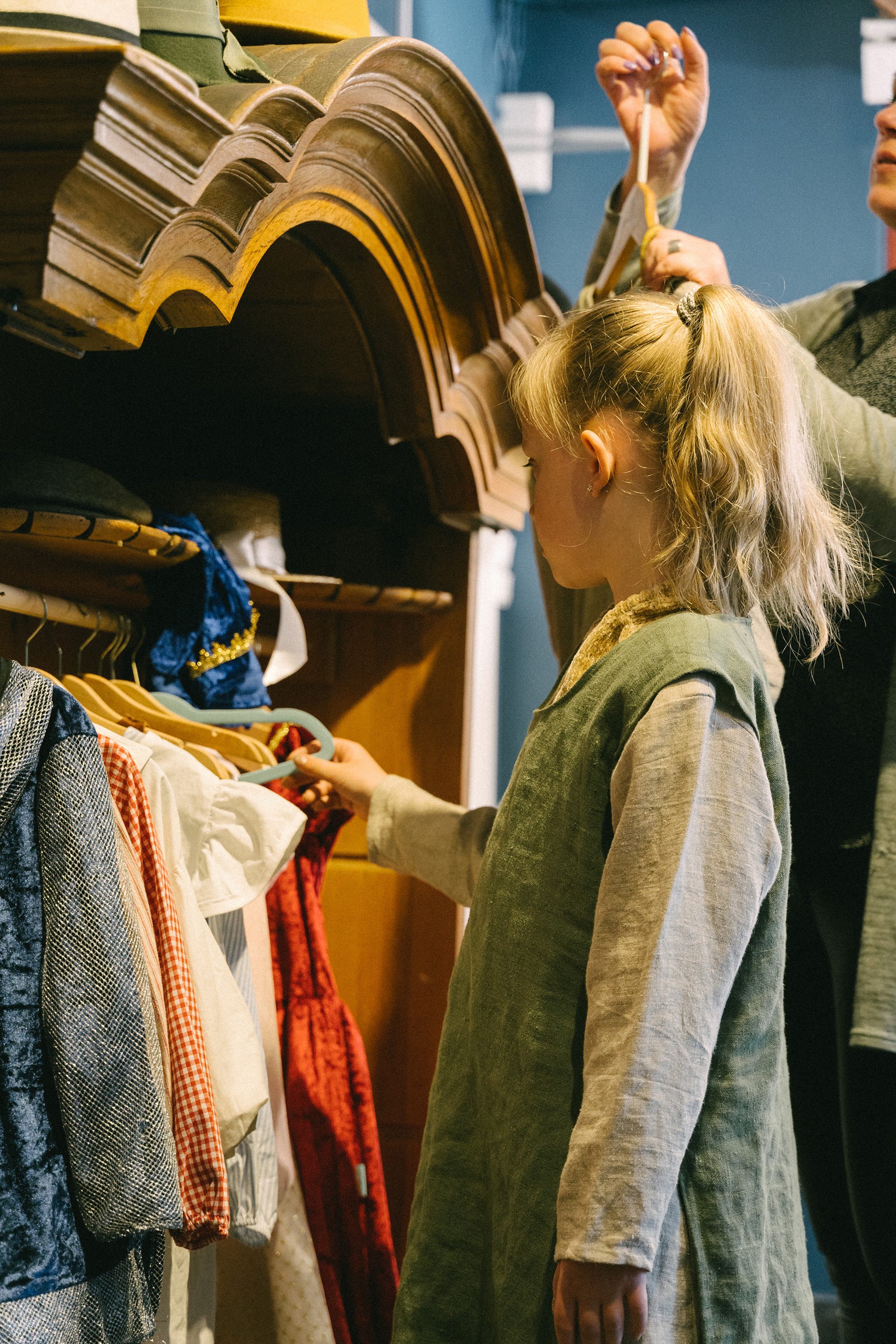 a girl trying on old-fashioned clothes