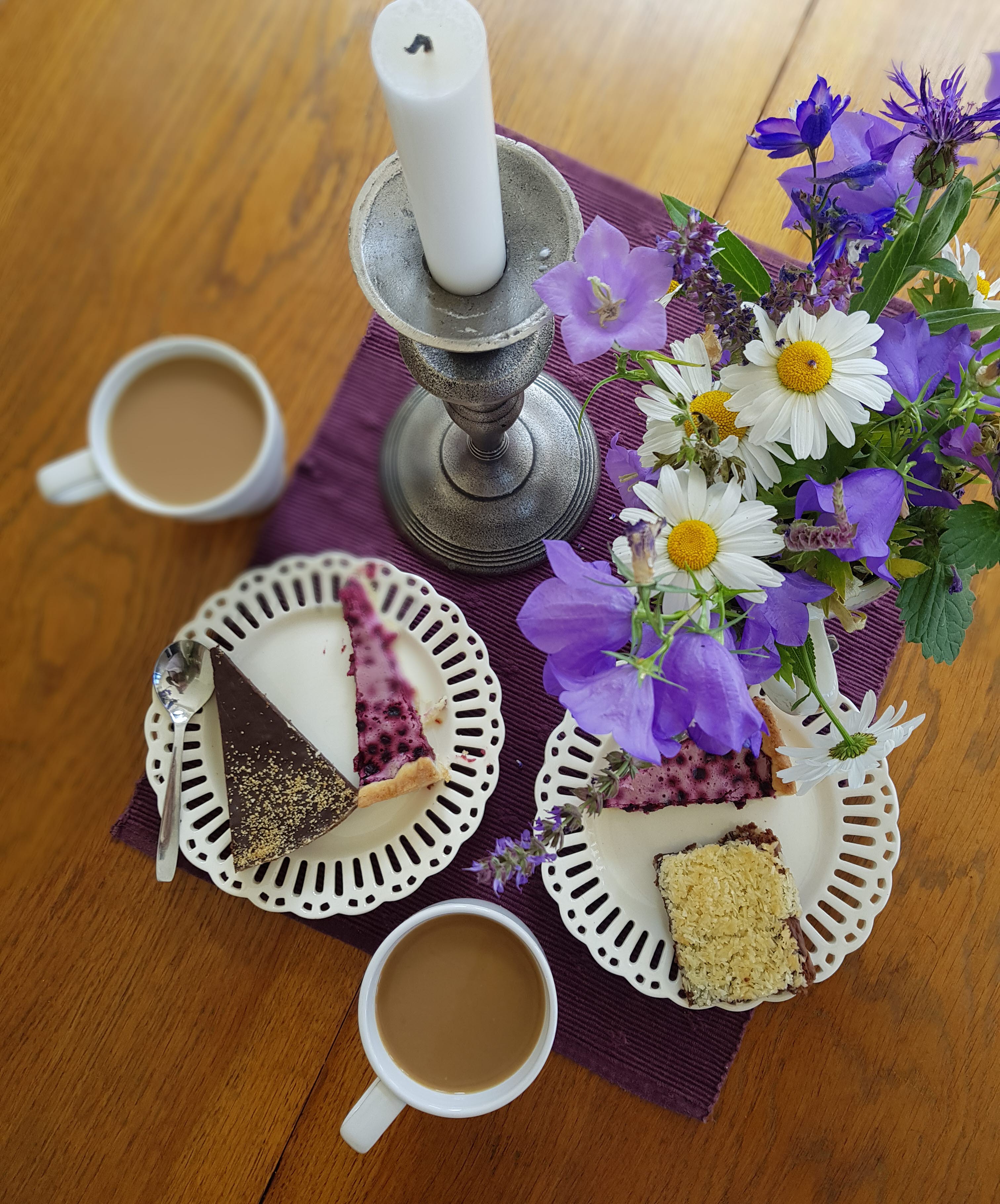 A small table with layed with coffee and pastries. 