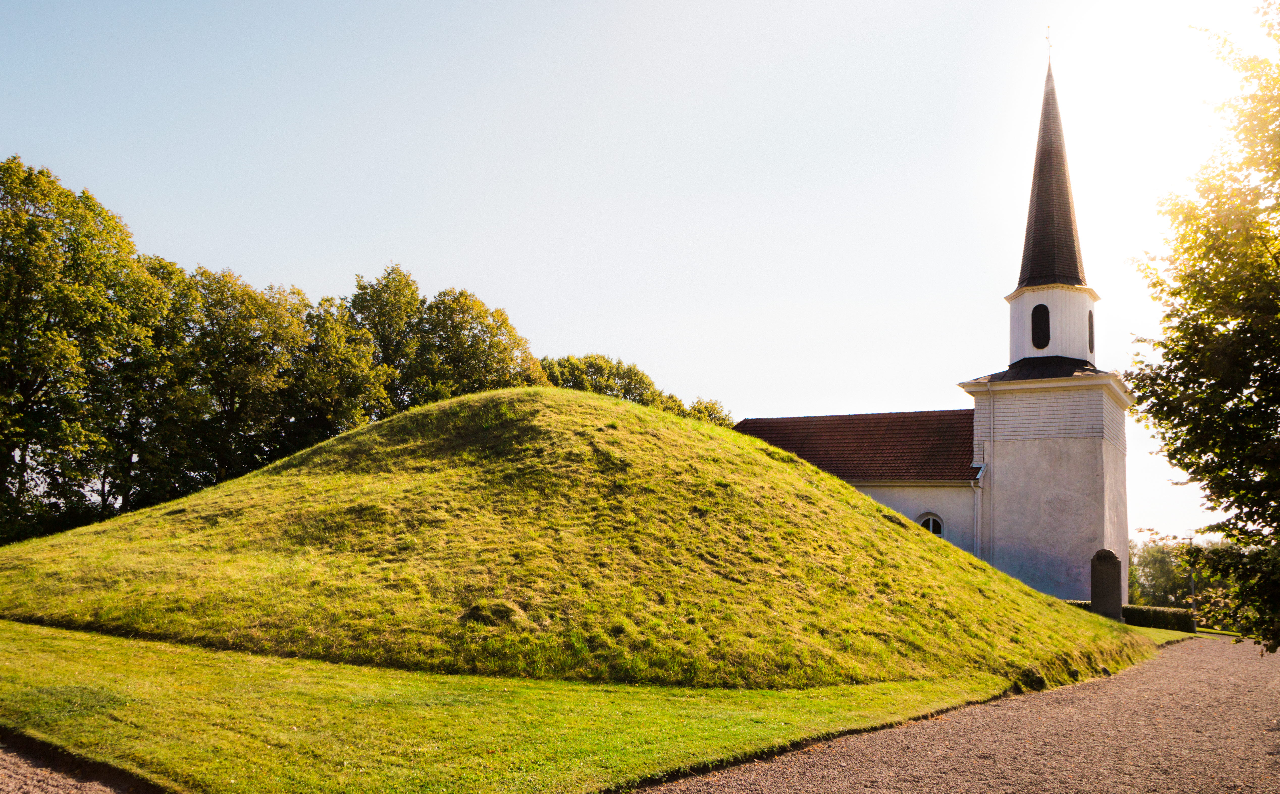A picture of King Rane's pile with Flistad church in the background