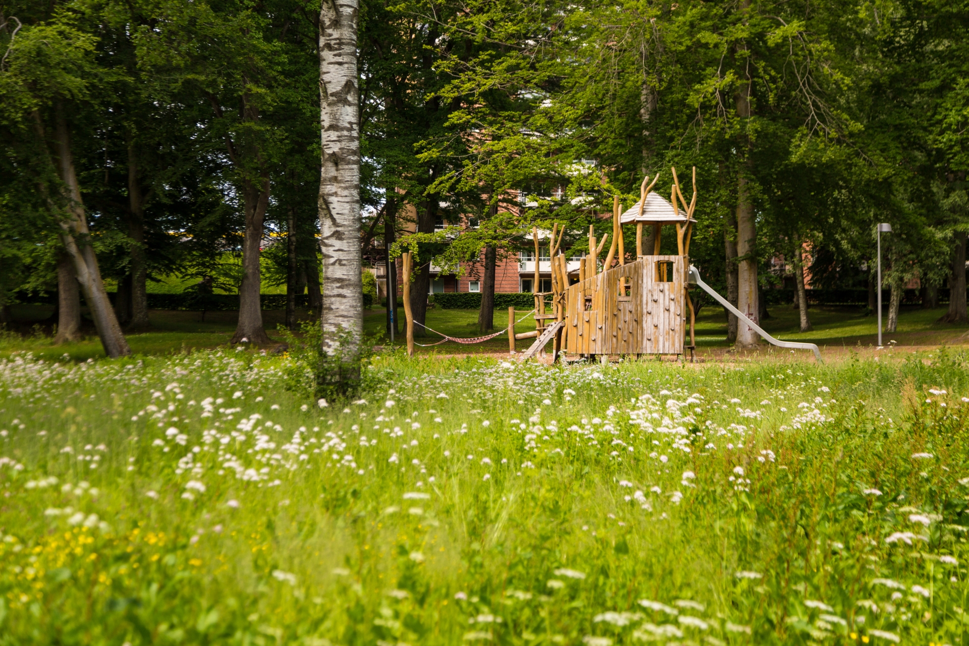 A playground in the boulogner forest surrounded by greenery
