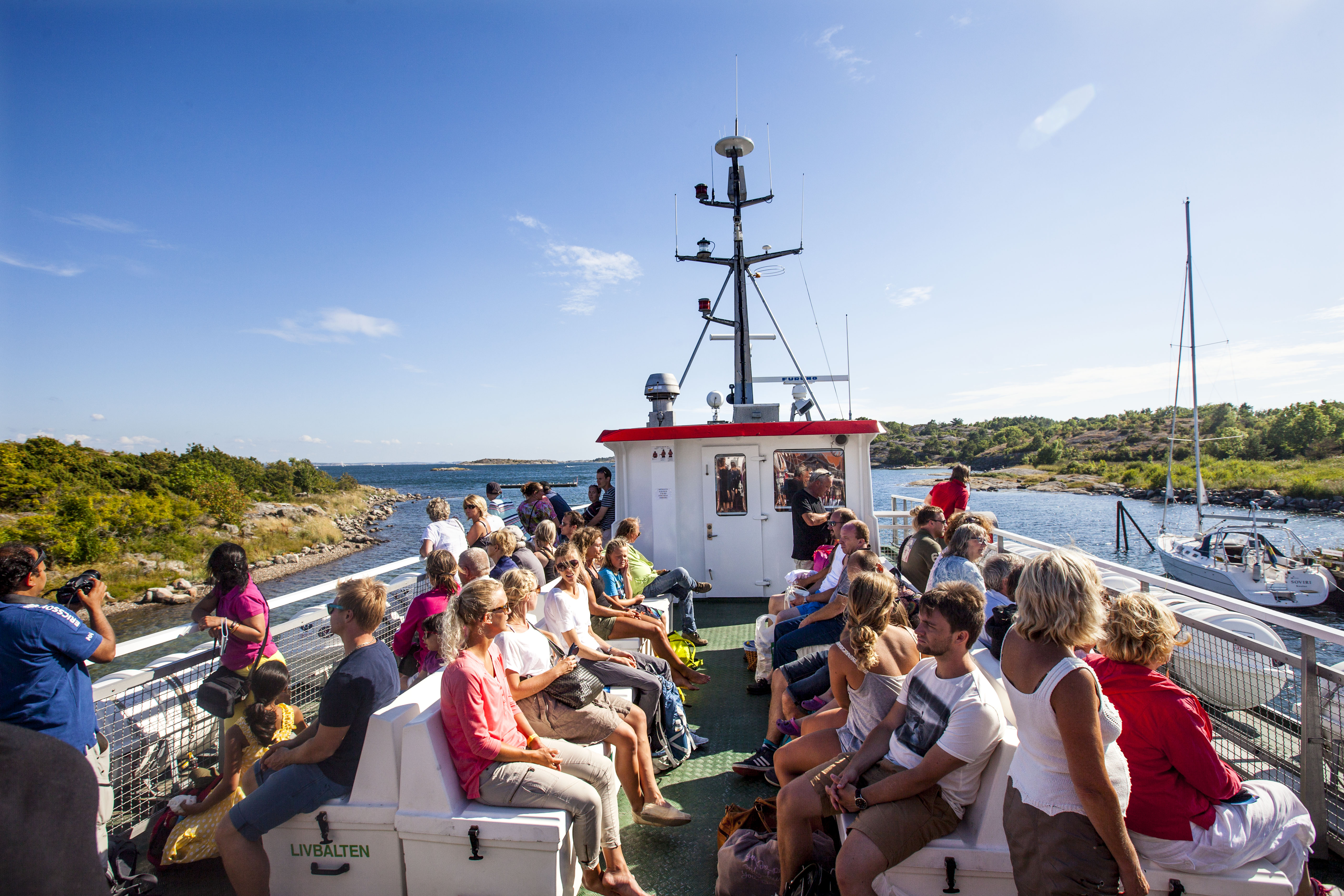 People sit on the upper deck on their way out to Koster Islands with the Koster boat.