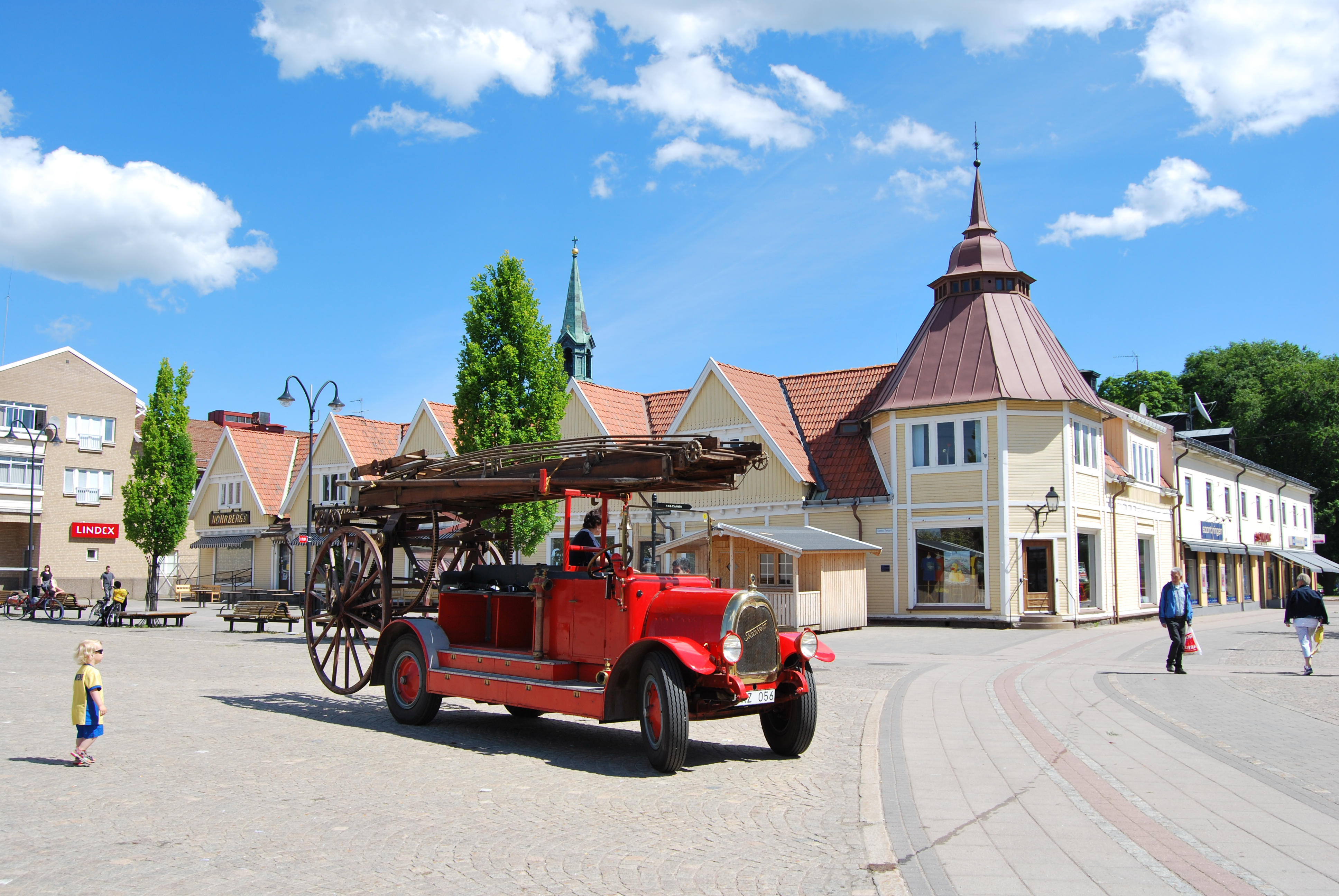 A really old red fire truck is on the Old Square in Tidaholm.
