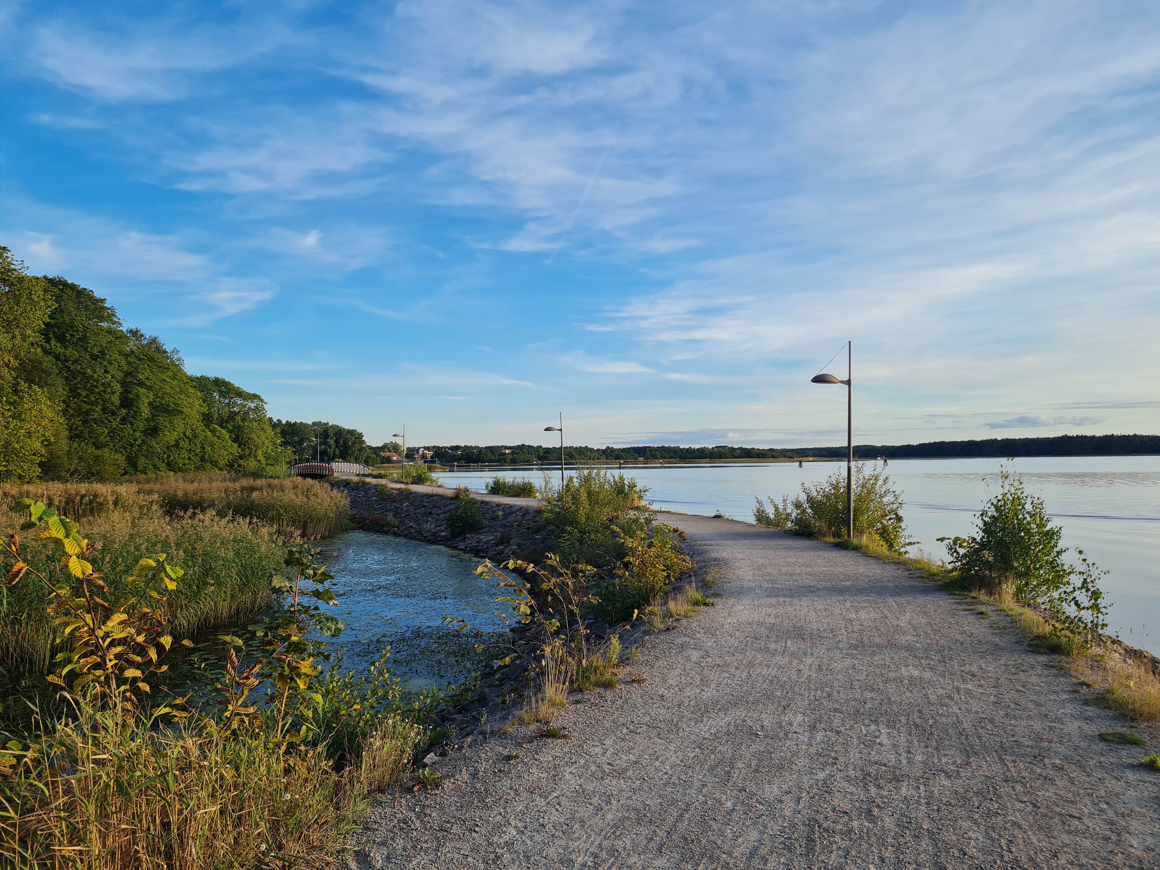 The path of Vänerparken along lake Vänern a sunny day