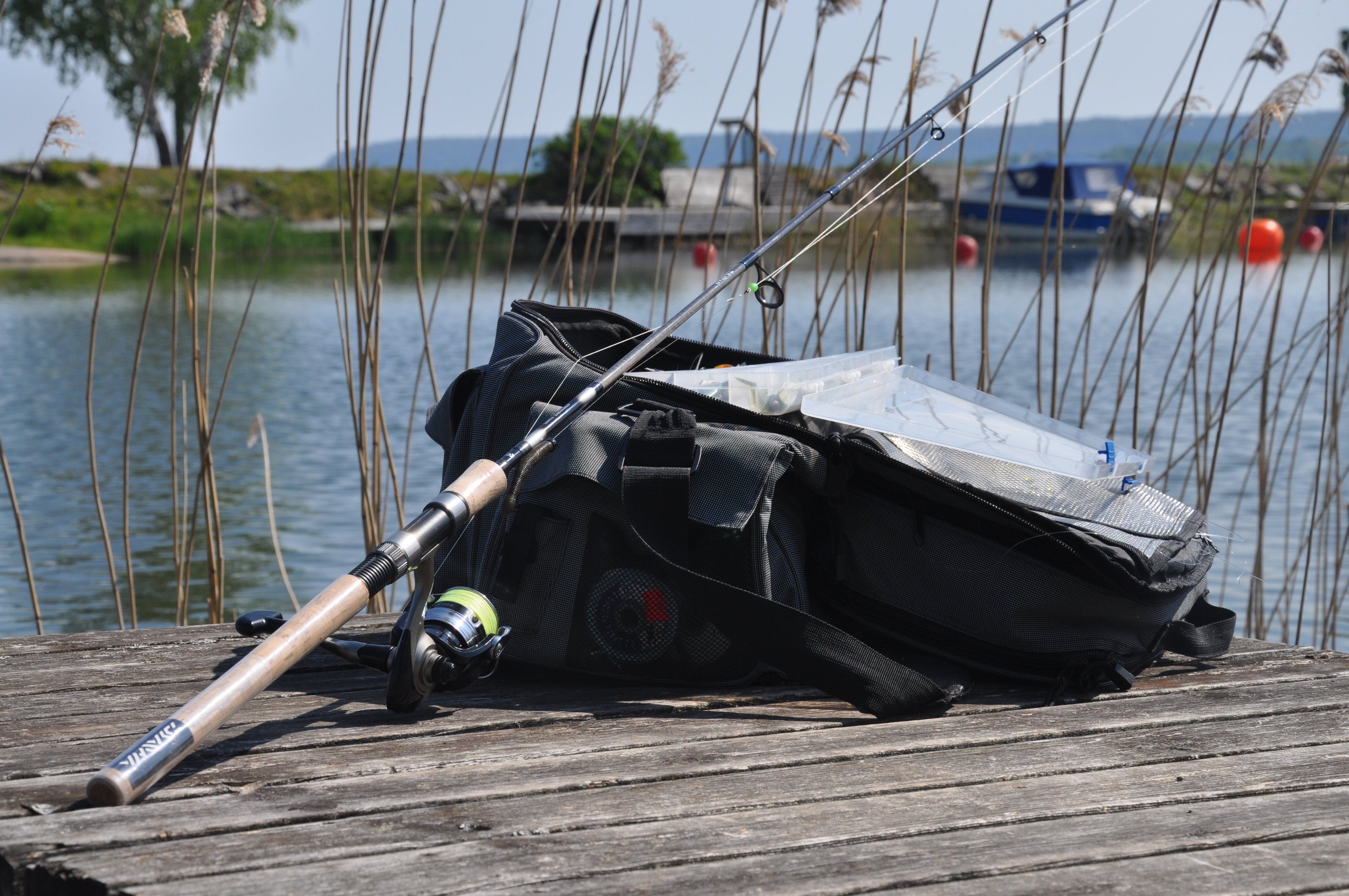 bag with fishing gear and fishing rod