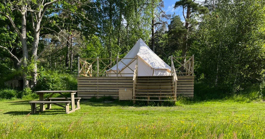 glamping tent at a meadow by the forest