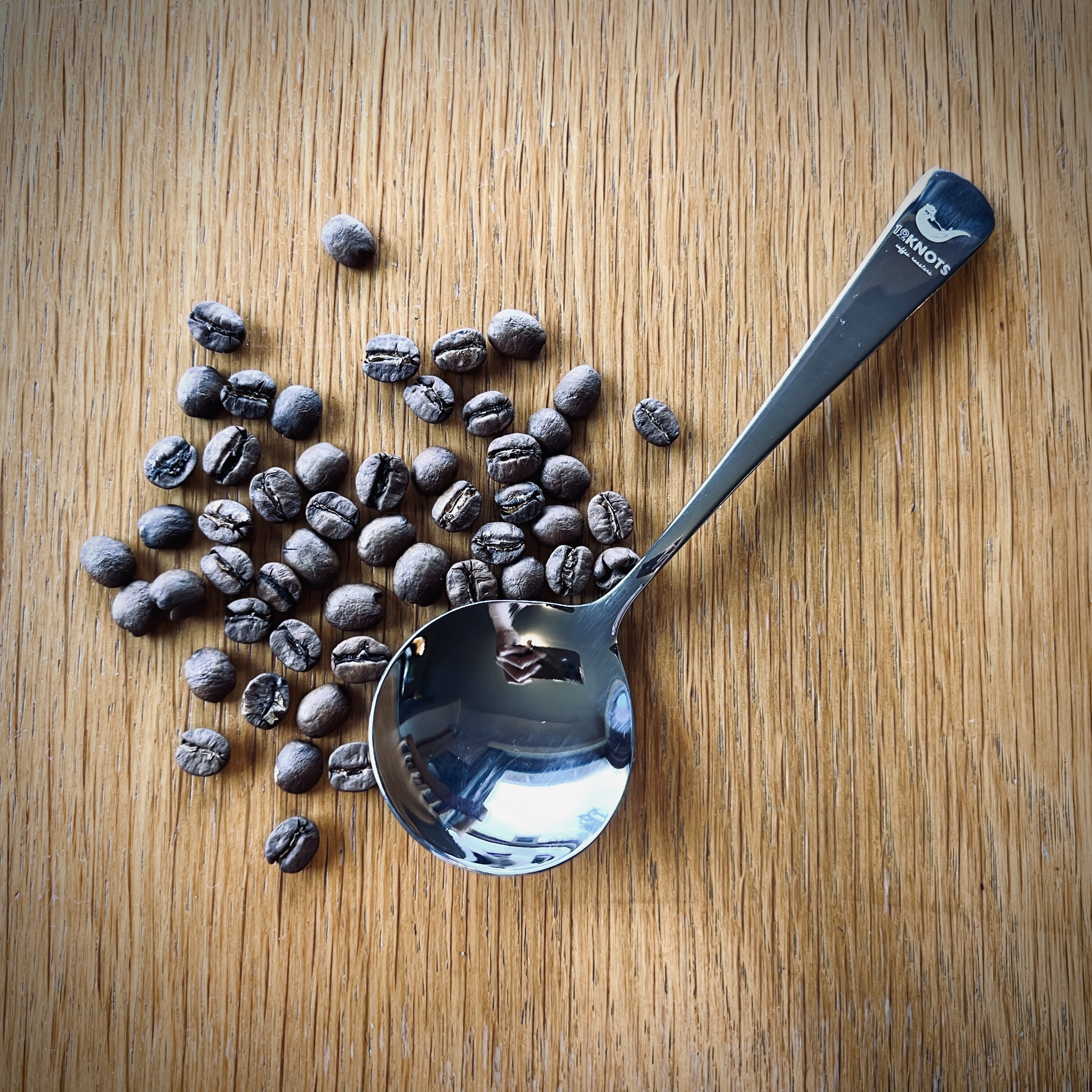 coffee beans and spoon at a table