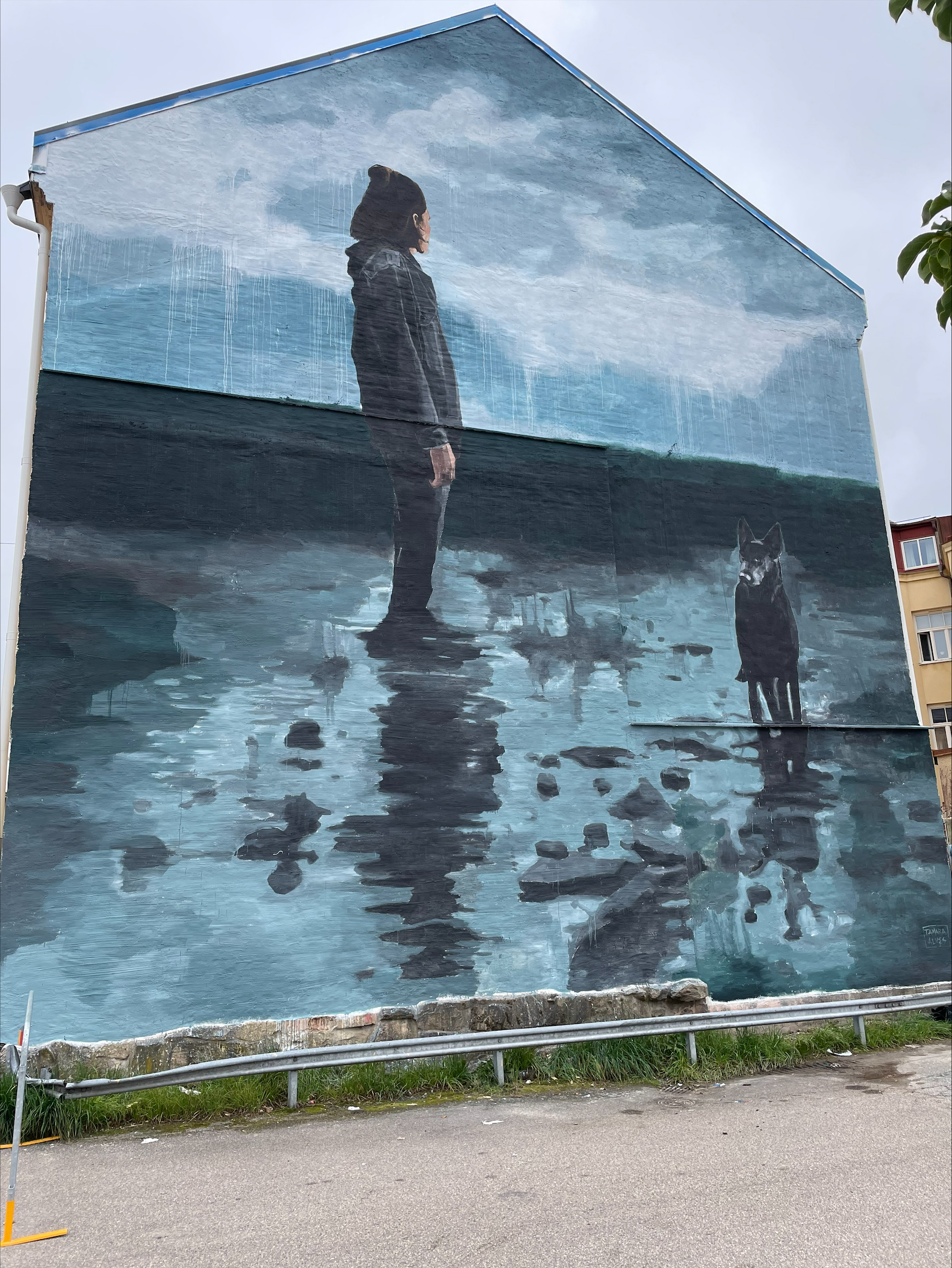 house fasad painted with a woman and a dog