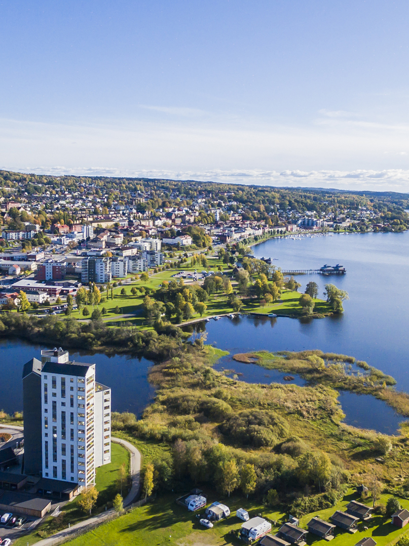 Blue lake Åsunden and some green fields and the city of Ulricehamn seen from above
