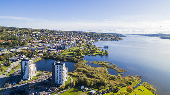 Blue lake Åsunden and some green fields and the city of Ulricehamn seen from above