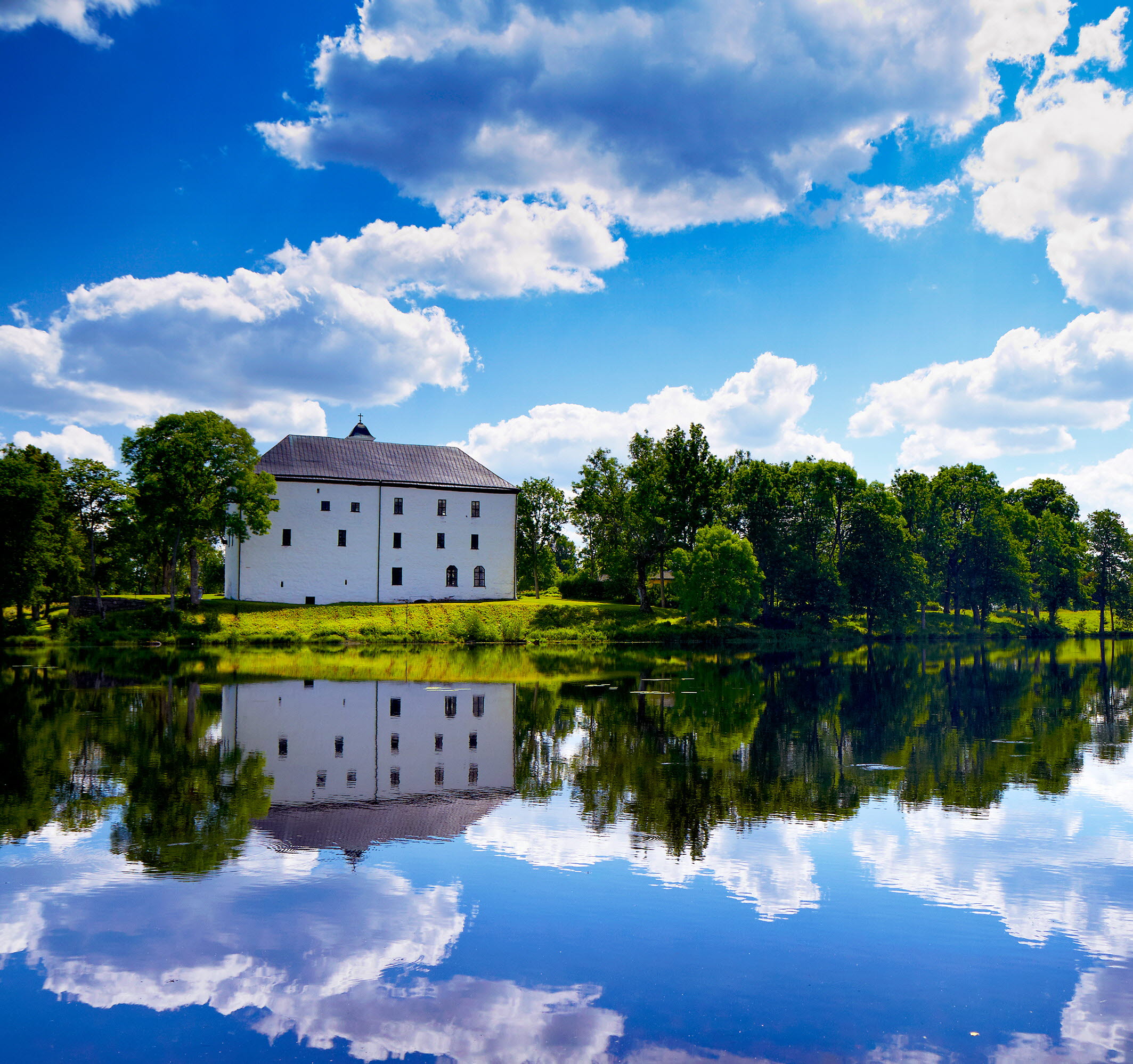 White castle with a lake infront